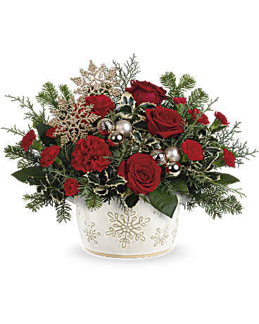 Red roses in a white snowflake-decorated container