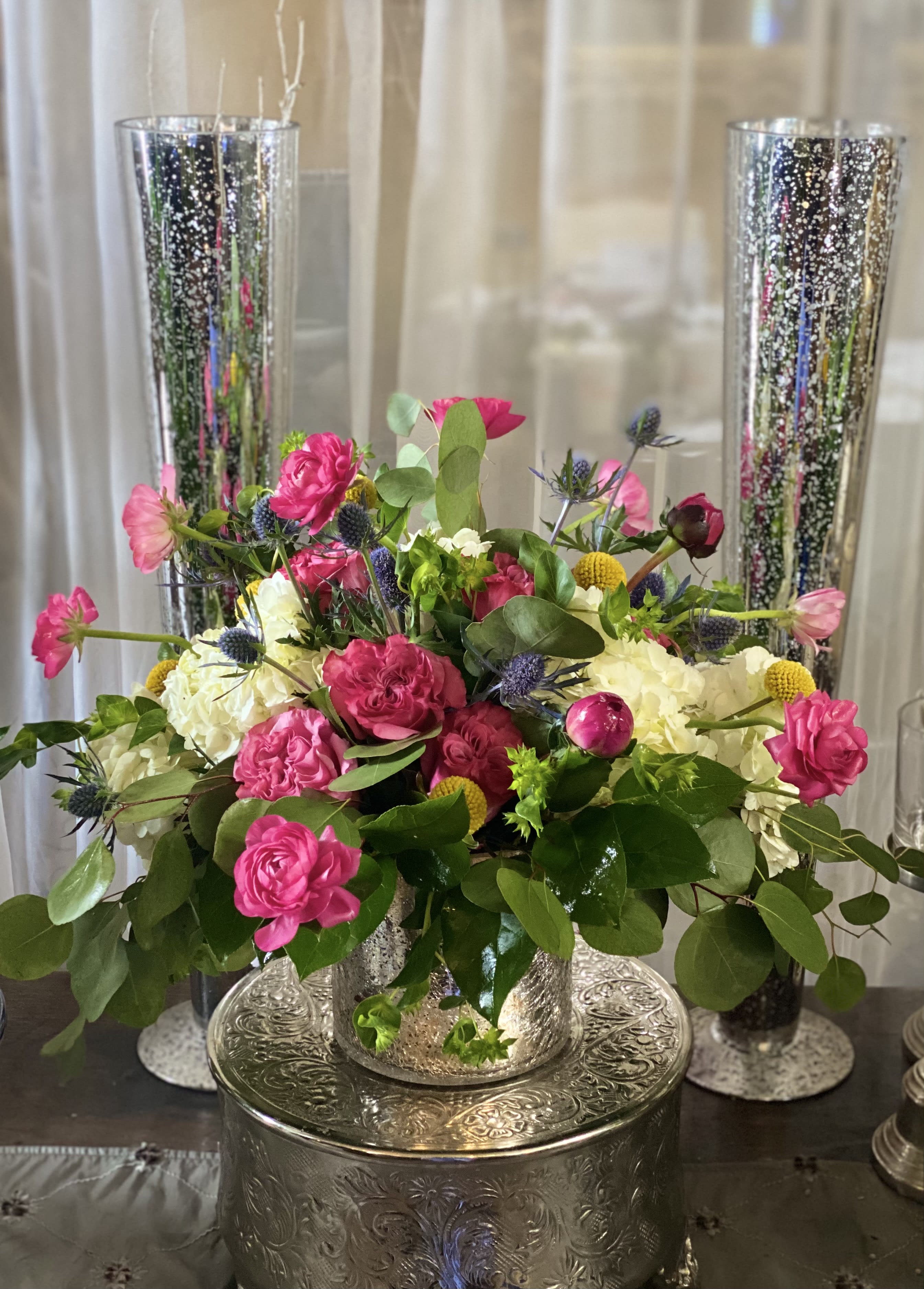 Pink and white floral arrangement in a silver vase