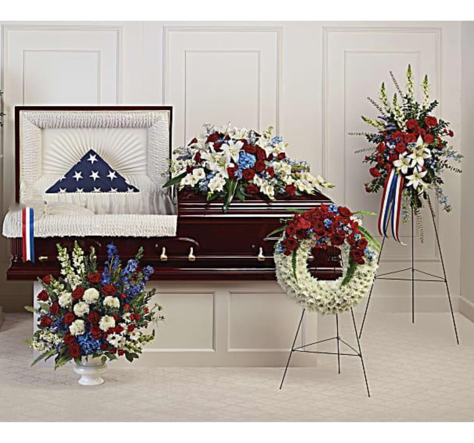 Funeral casket with patriotic floral sprays and wreaths