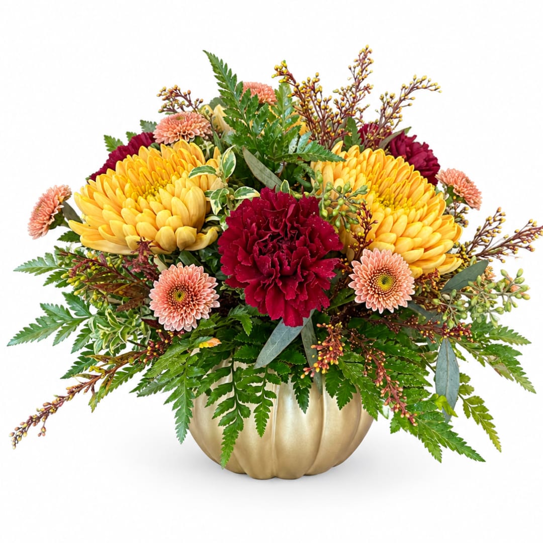 Yellow and burgundy flowers arranged in a gold pumpkin vase