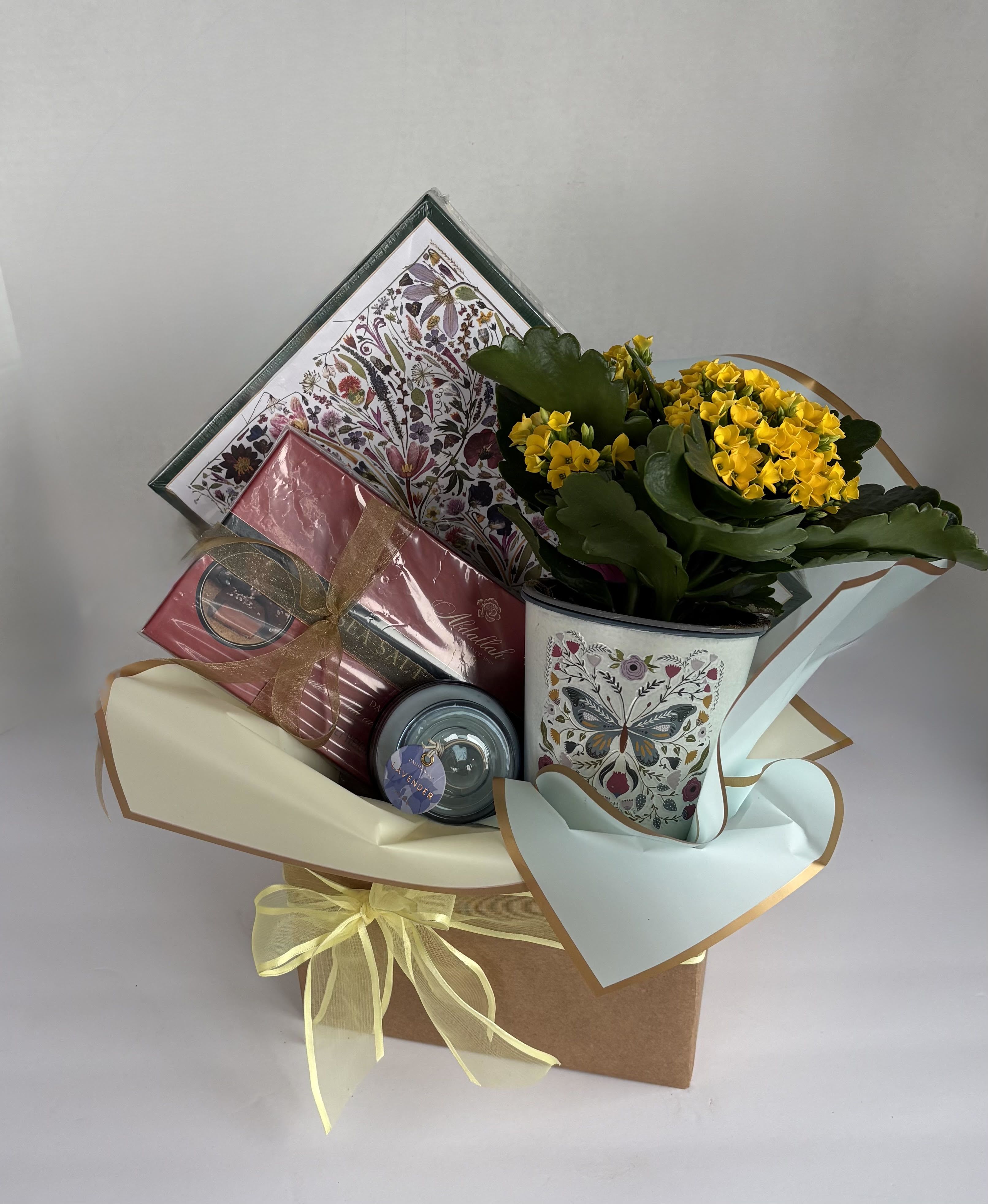 Blooming Gift Set  - This gift set includes all the bits and bobs for any special occasion. Included in this cheerful collection is: One 4.5inch blooming plant with a lovely butterfly tin, one small paddy wax candle, one puzzle, and one medium box of chocolates. Call to customize your own special gift set, or entrust our team to specialize a gift set for you!
