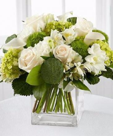 Legacy Clouds - This all white arrangement includes roses, lisianthus and hydrangeas. This is a perfect design for any occasion.   APPROXIMATE DIMENSIONS 15" W X 13" H