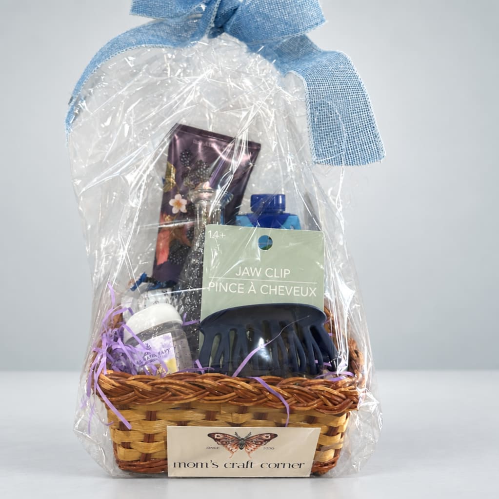 Gift basket with hair accessories and small personal care items in plastic wrap