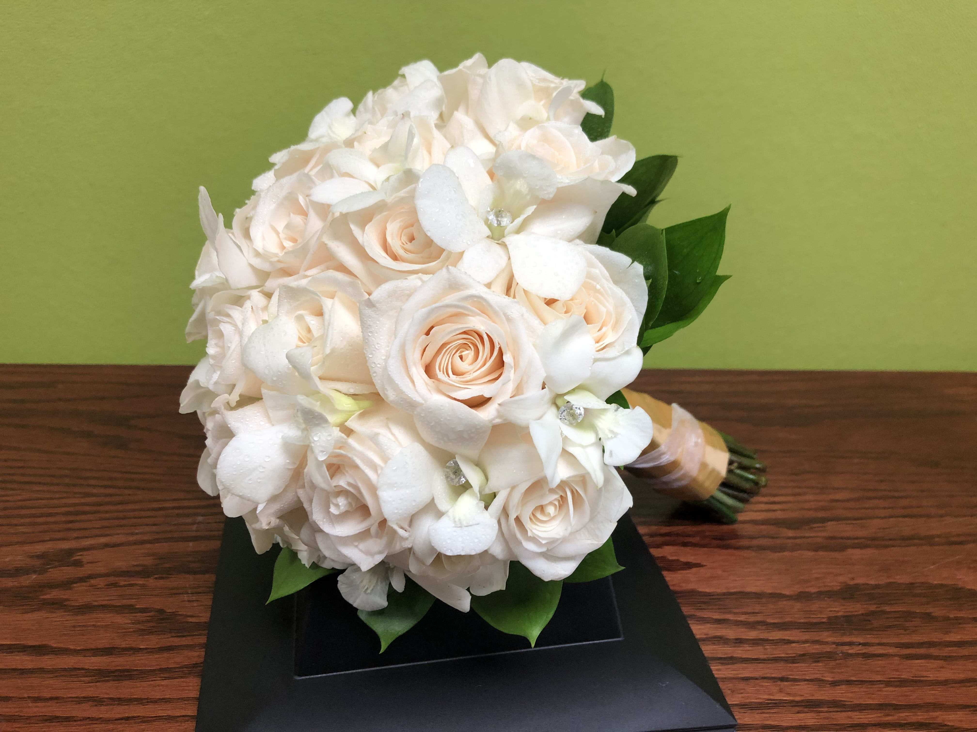 White and blush bridal bouquet with roses and orchids