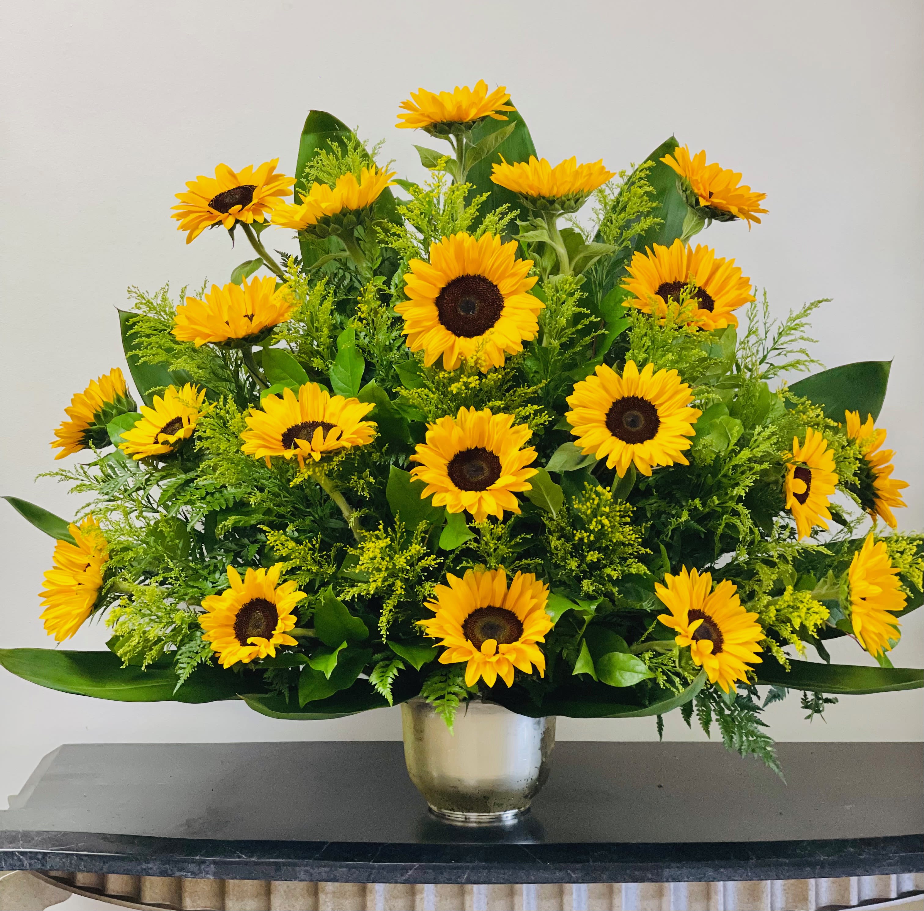 Sunflower arrangement in a silver vase