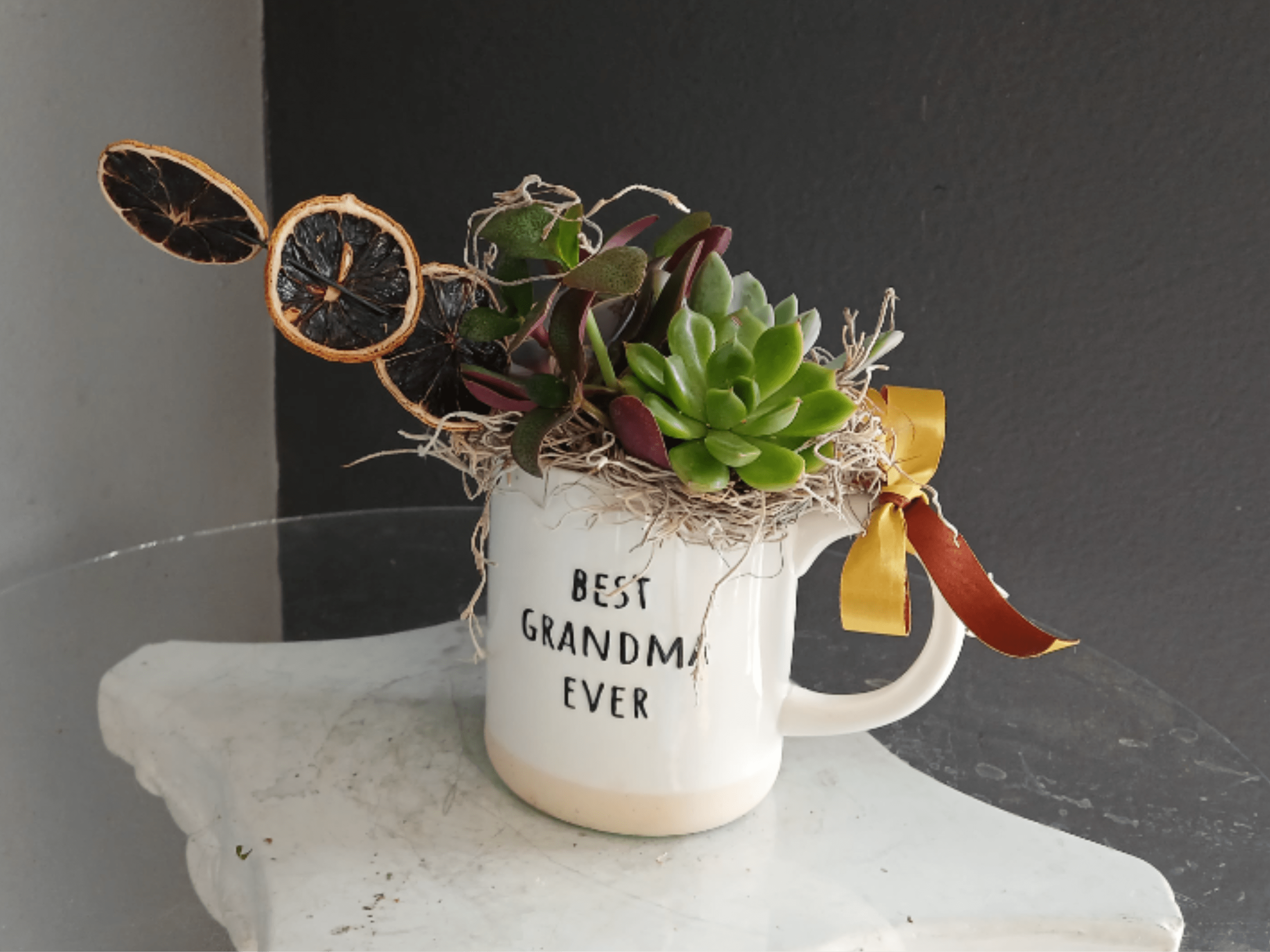 Best Grandma Ever Succulent with Oranges - Precious succulent arrangement in a mug with a dried orange accent