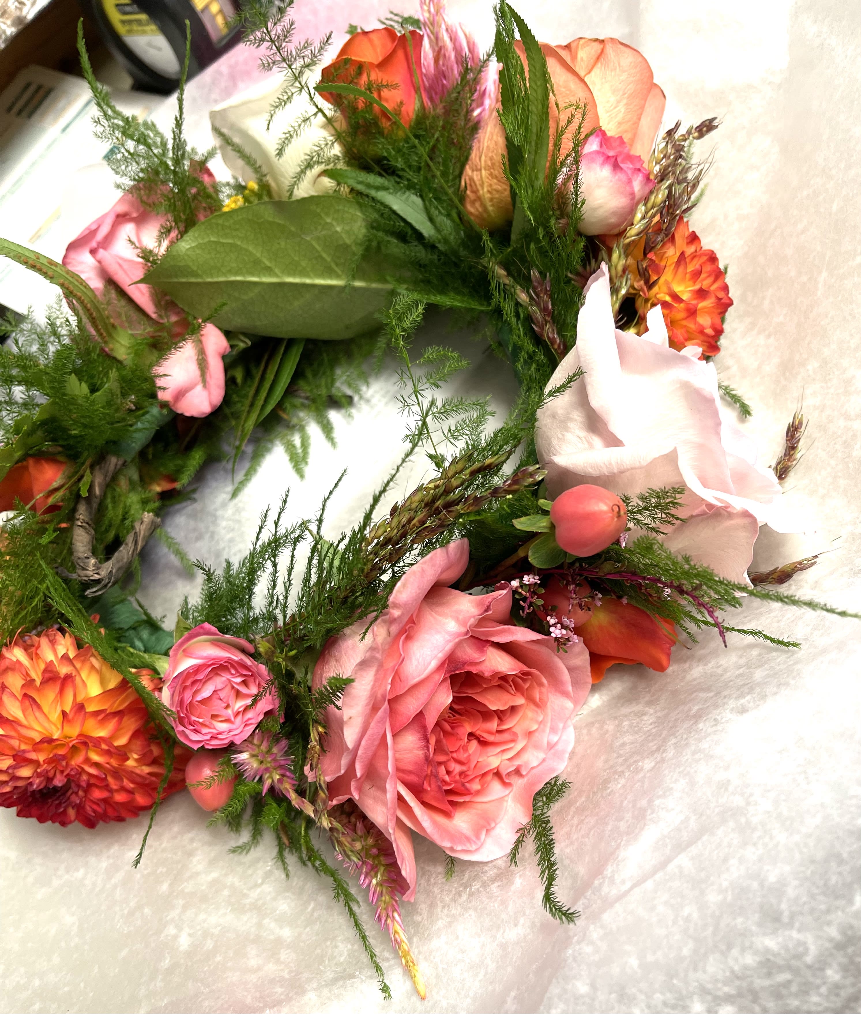 Pink and orange floral wreath with roses and dahlias