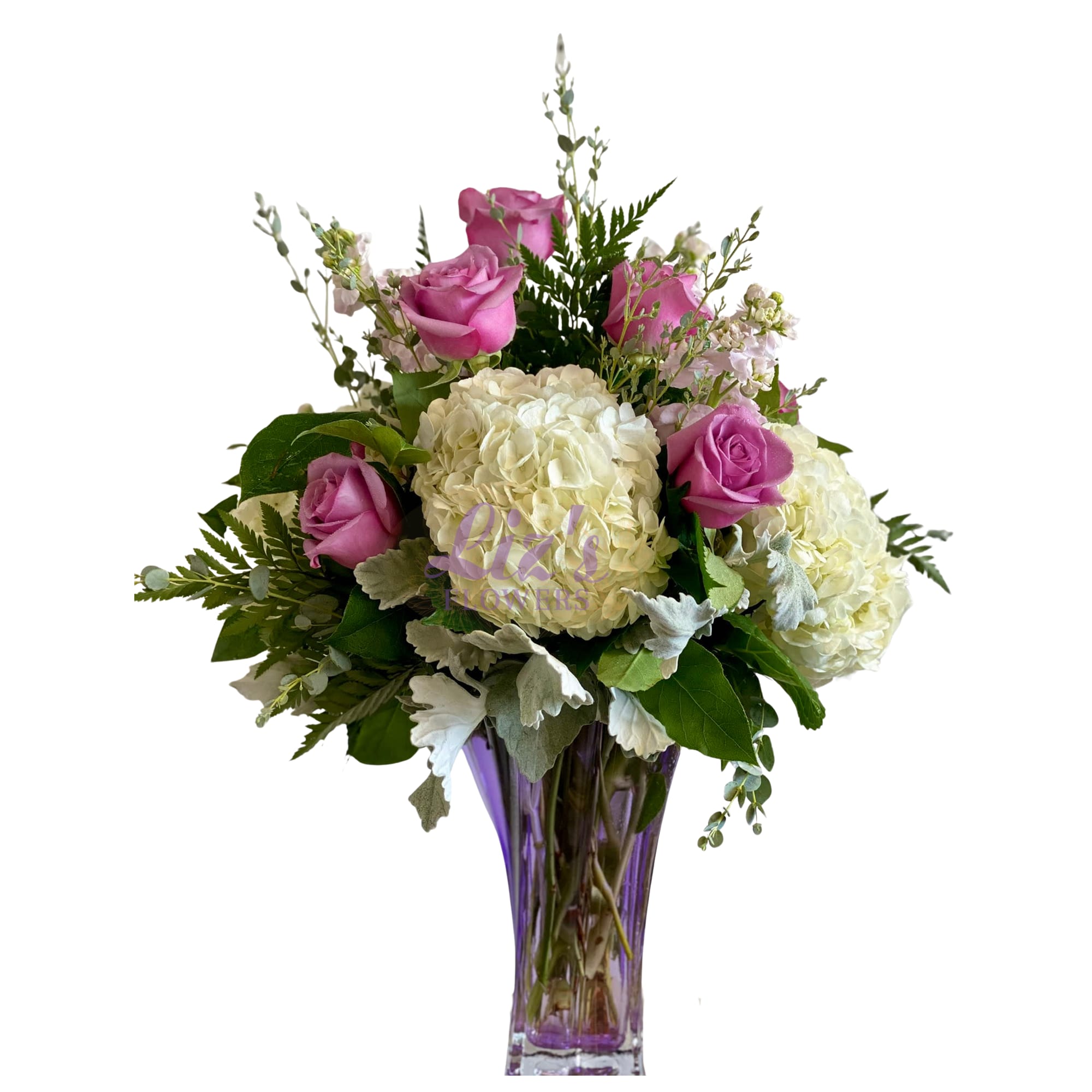 Pink roses and white hydrangeas in a purple glass vase