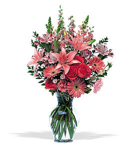 Pink and red mixed flower bouquet in a clear glass vase