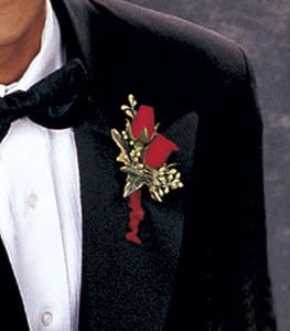 Red rose boutonniere pinned to a black tuxedo jacket