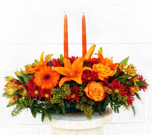 Autumn Delight by D Bryant Designer - This gracious centerpiece will delight everyone at the table. Made from only the freshest and finest flowers and accessories. We adore it with 2 15" dripless taper candles. Colors and flowers will vary due to availability.