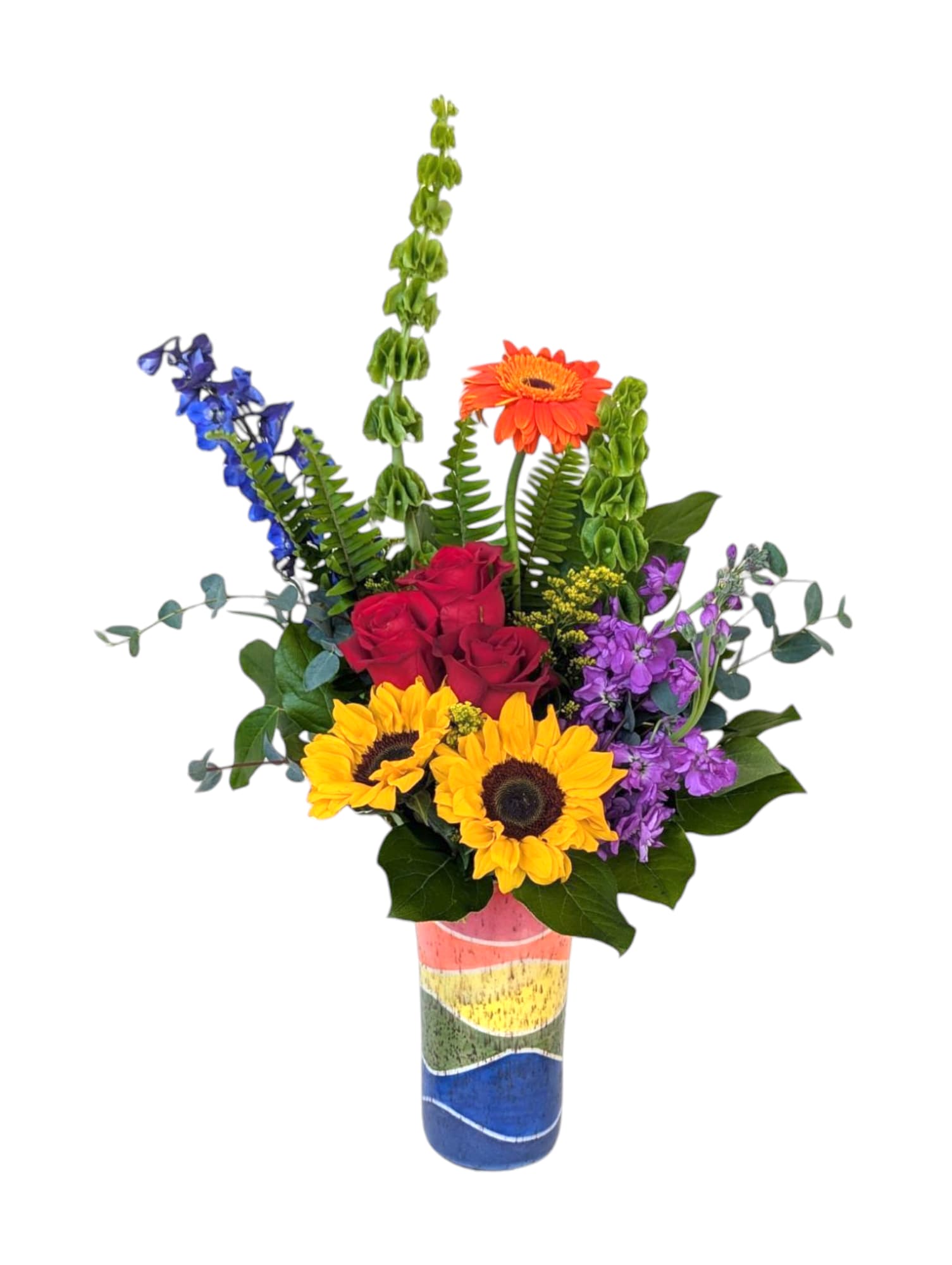 Spectrum by Art &amp; Flowers - Our featured design for June celebrates color, community and love. A vibrant arrangement of rainbow blooms is paired with a tall, hand-thrown colorful vase made by a local potter, Tina Christensen. Each vase is slightly different and one of a kind. This arrangement is bold and joyful for all those special moments in your life! 