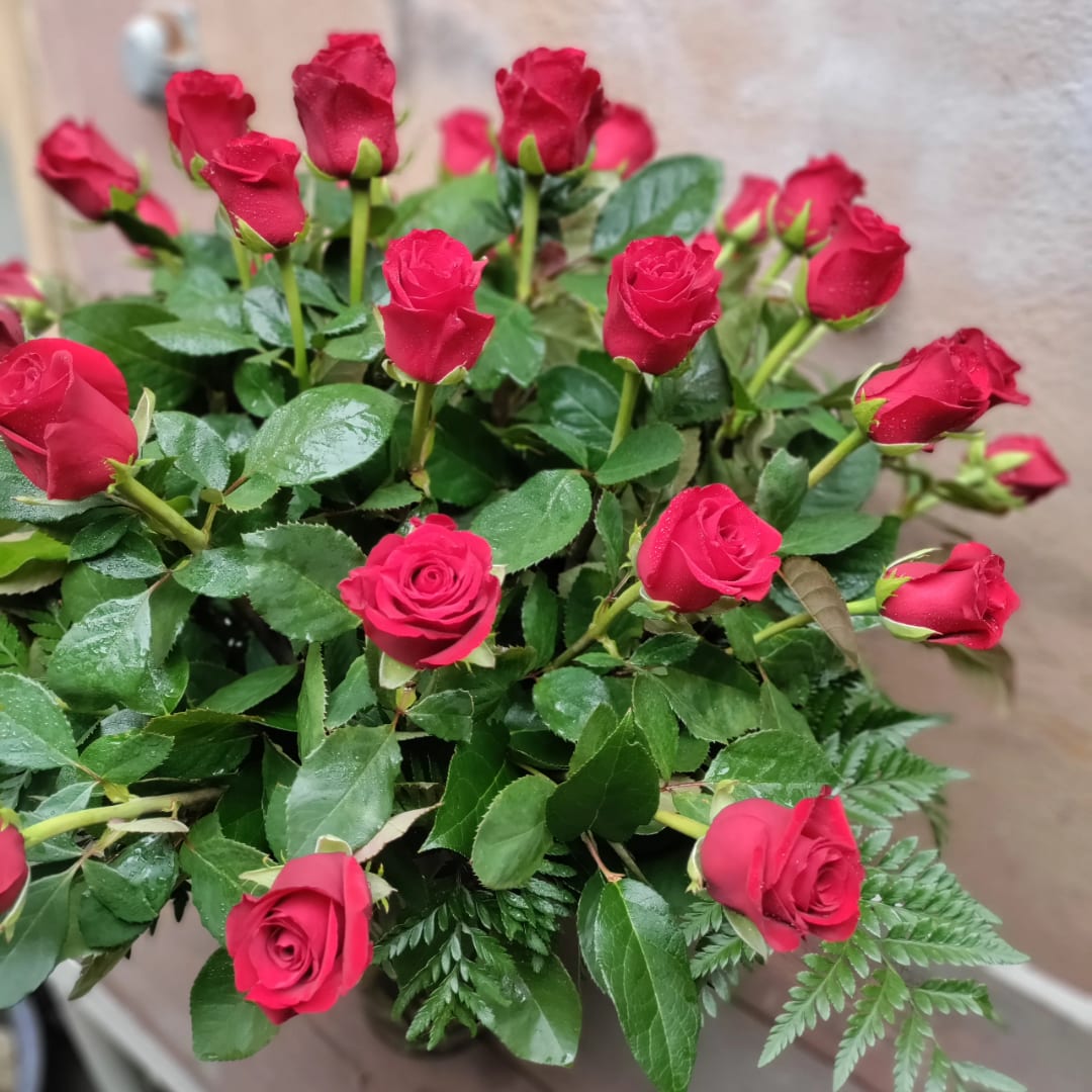 Bouquet of red roses with glossy green foliage