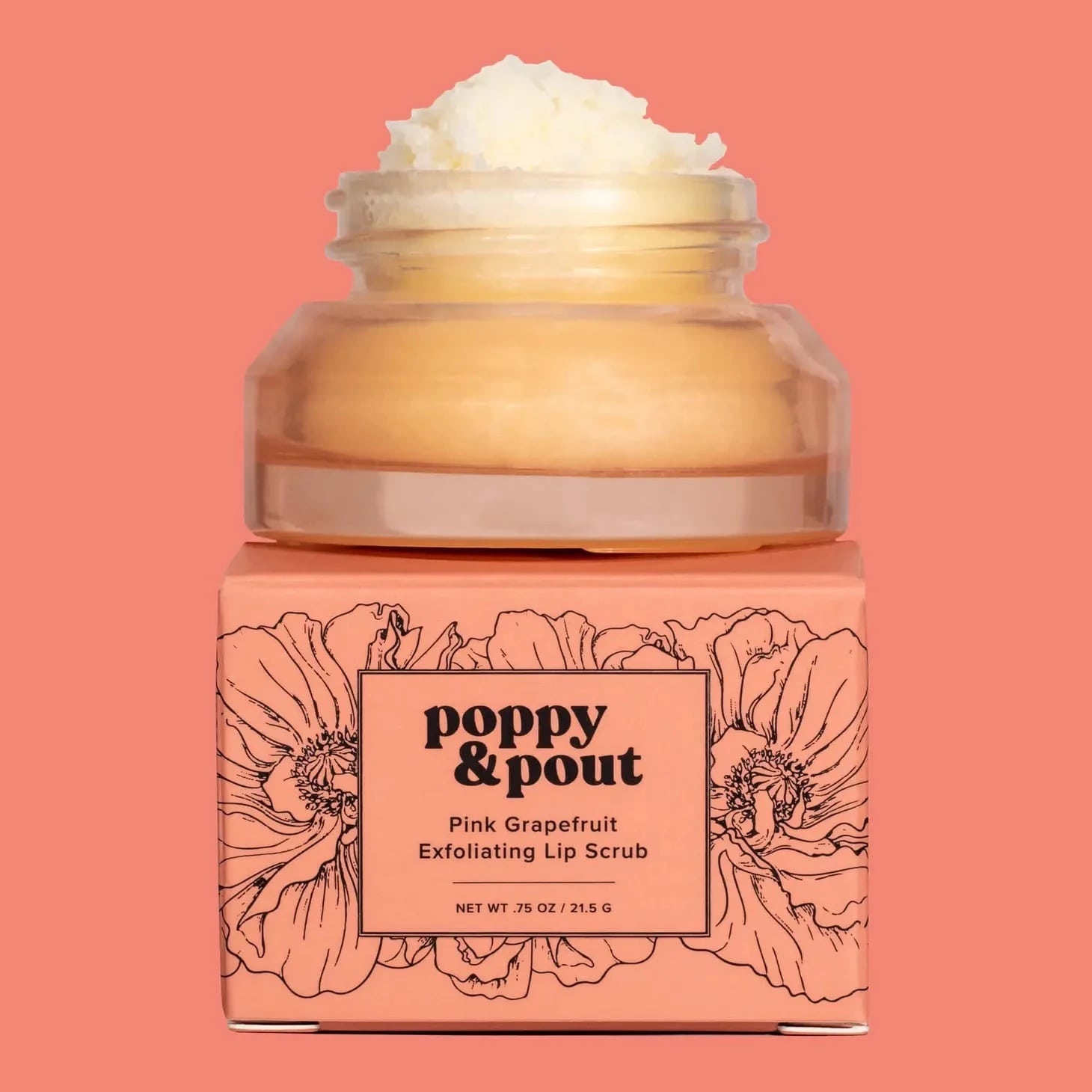 Pink grapefruit lip scrub in a jar on a peach box
