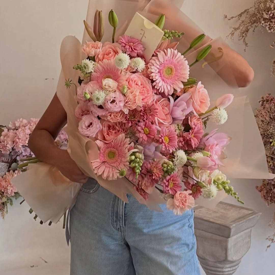 Pink mixed bouquet wrapped in translucent paper