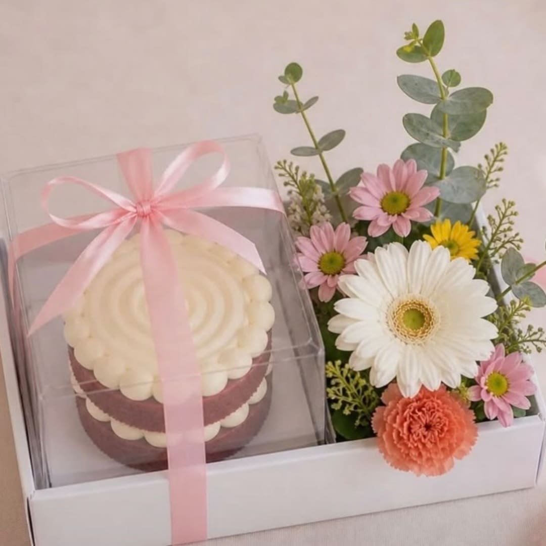 Gift box with a cupcake and a small flower arrangement