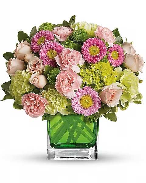 Pink and green mixed bouquet in a square glass vase
