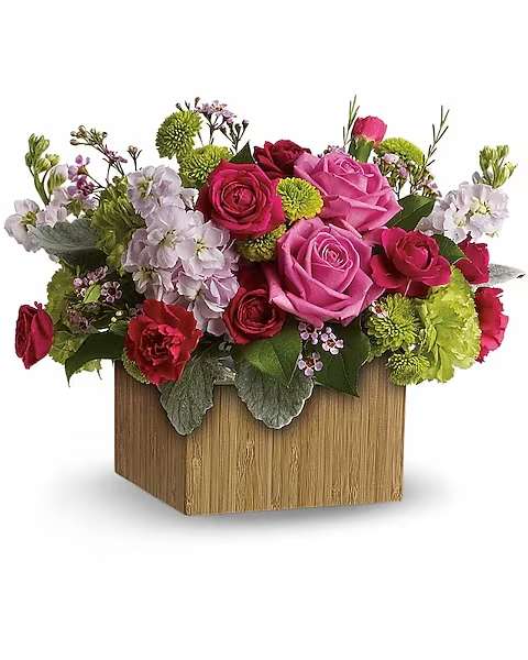Pink and red rose arrangement in a wooden box