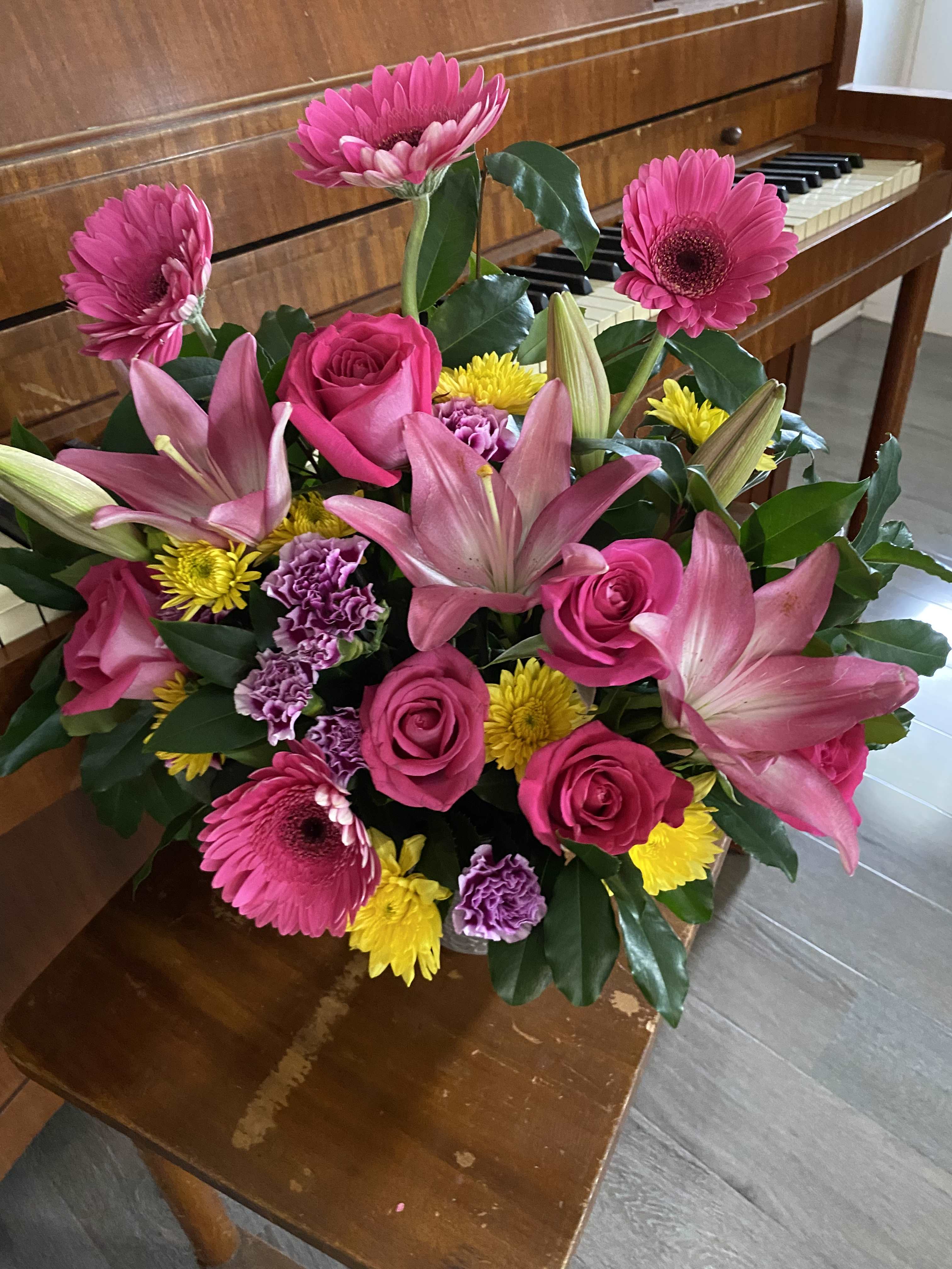 Bouquet of pink lilies, roses, gerbera daisies, and yellow mums