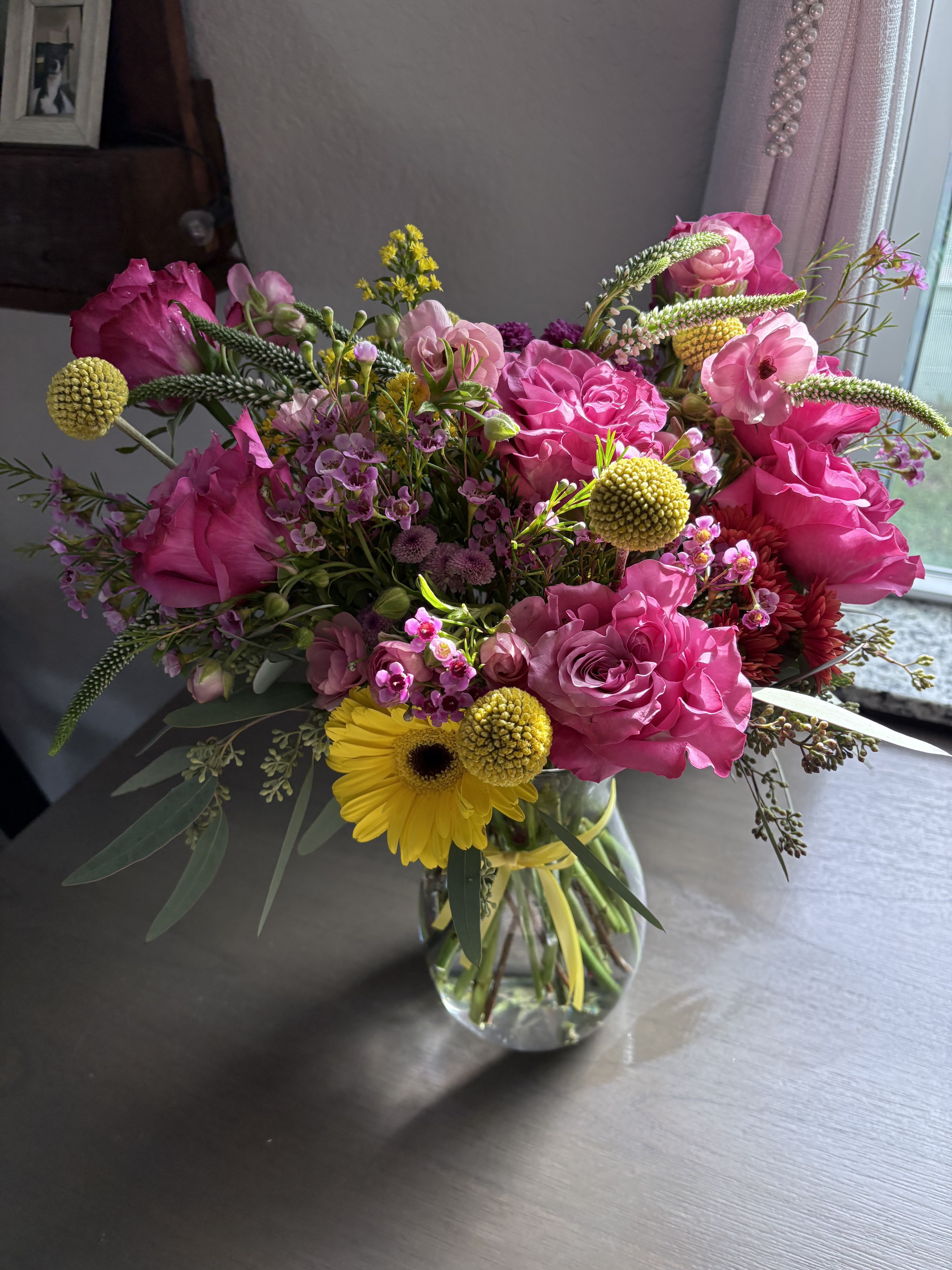 Pink and yellow mixed bouquet in a clear glass vase