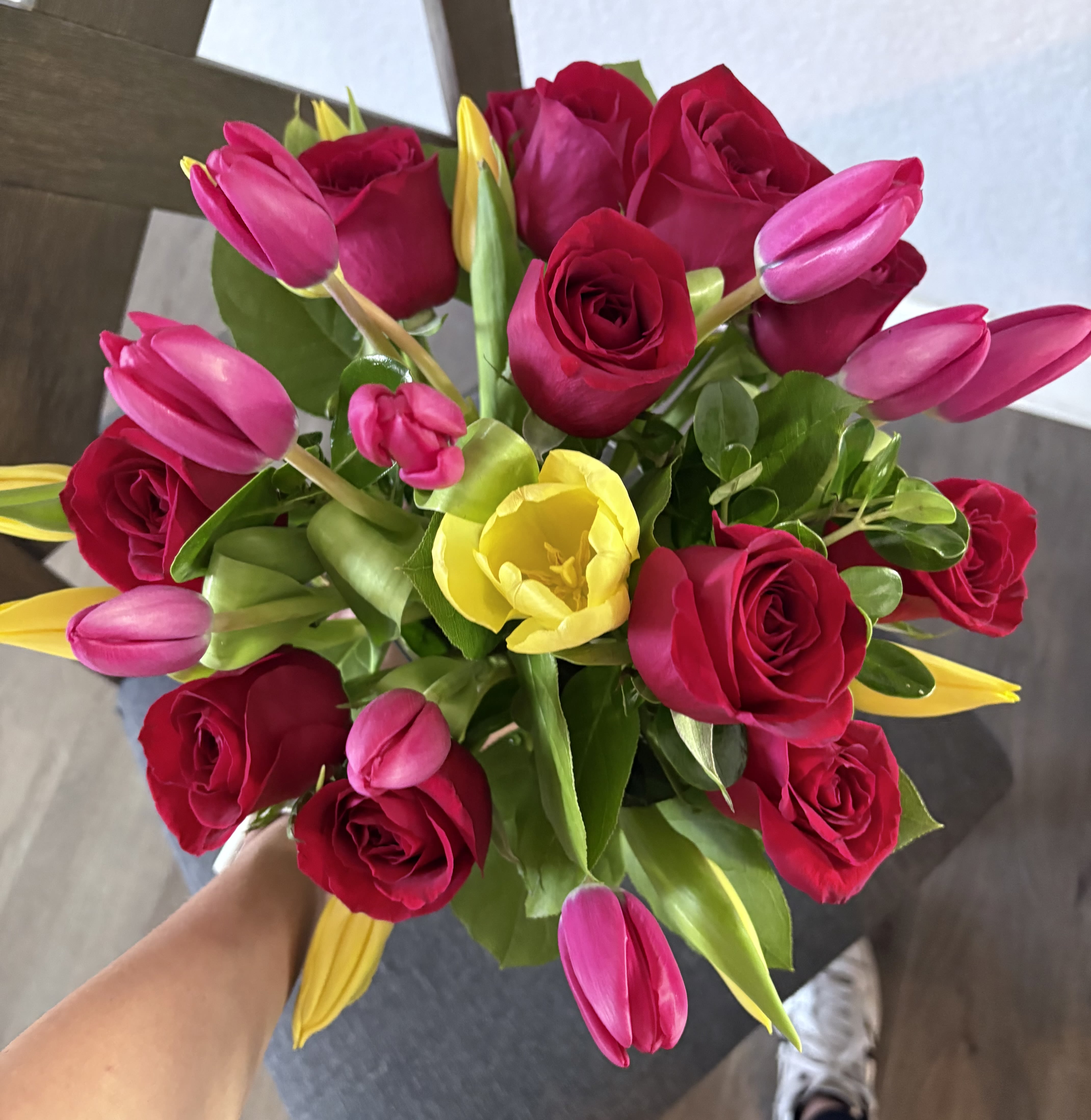 Bouquet of red roses with pink and yellow tulips