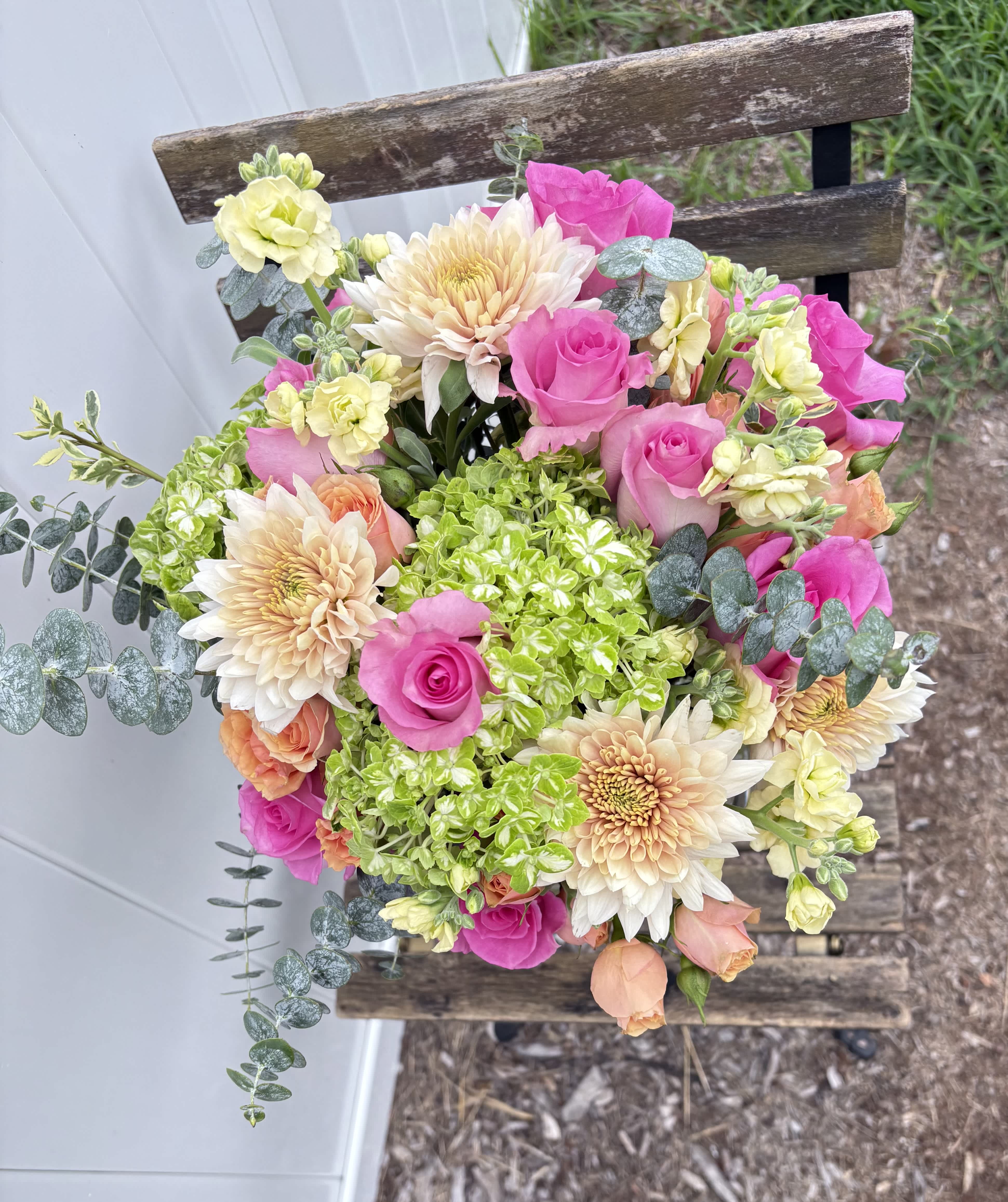 Bouquet of pink roses, cream dahlias, and green hydrangeas