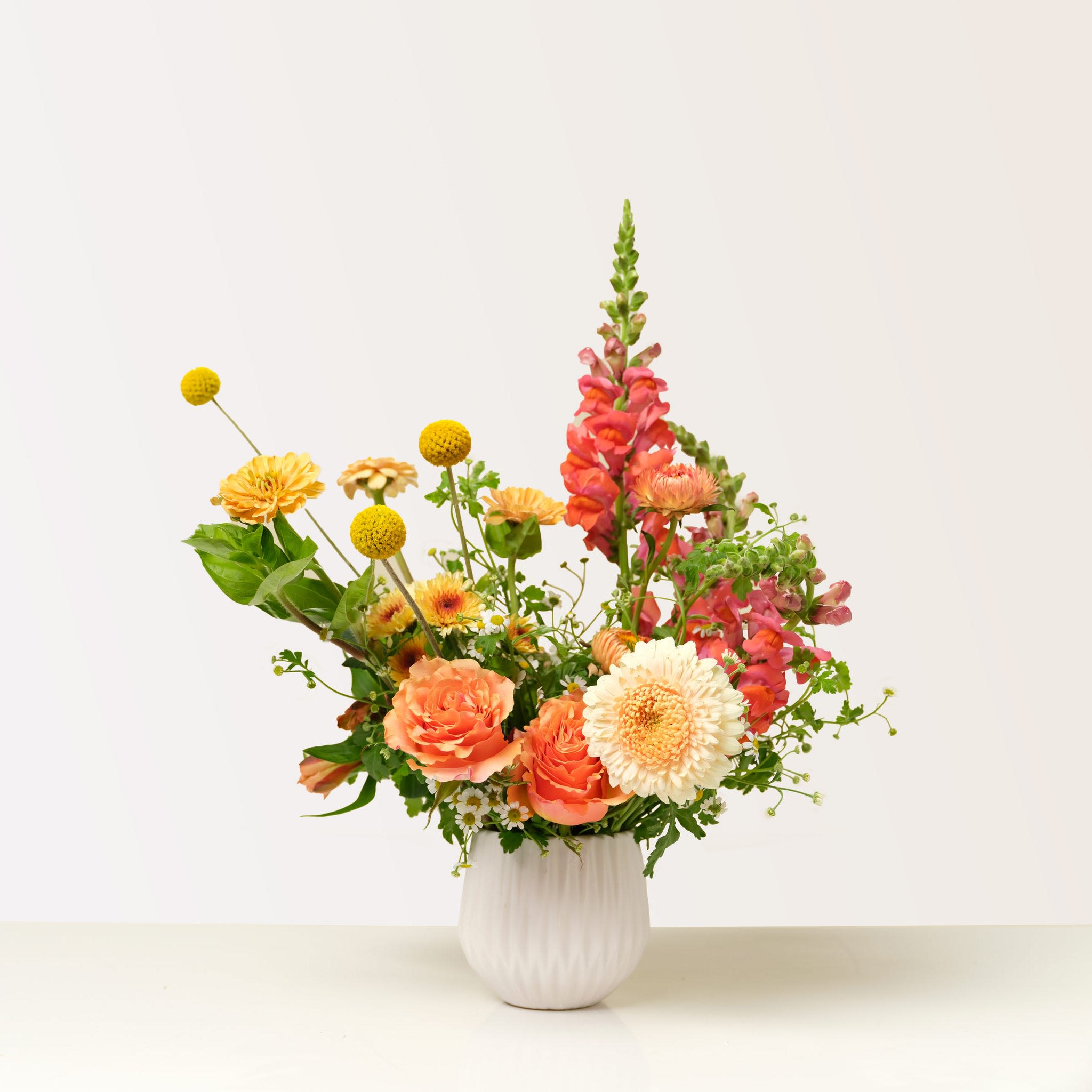 Eloise - Pretty lovely flowers! This arrangement will brighten anyone's day. We artfully arrange flowers that make a splash of color. Great for all occasions and sentiments. We favor in season, locally grown flowers. Heirloom mums and gerbera daisies, chamomile, dahlias, snapdragon, stock, dahlias, and an assorted variety of roses in bright colors.