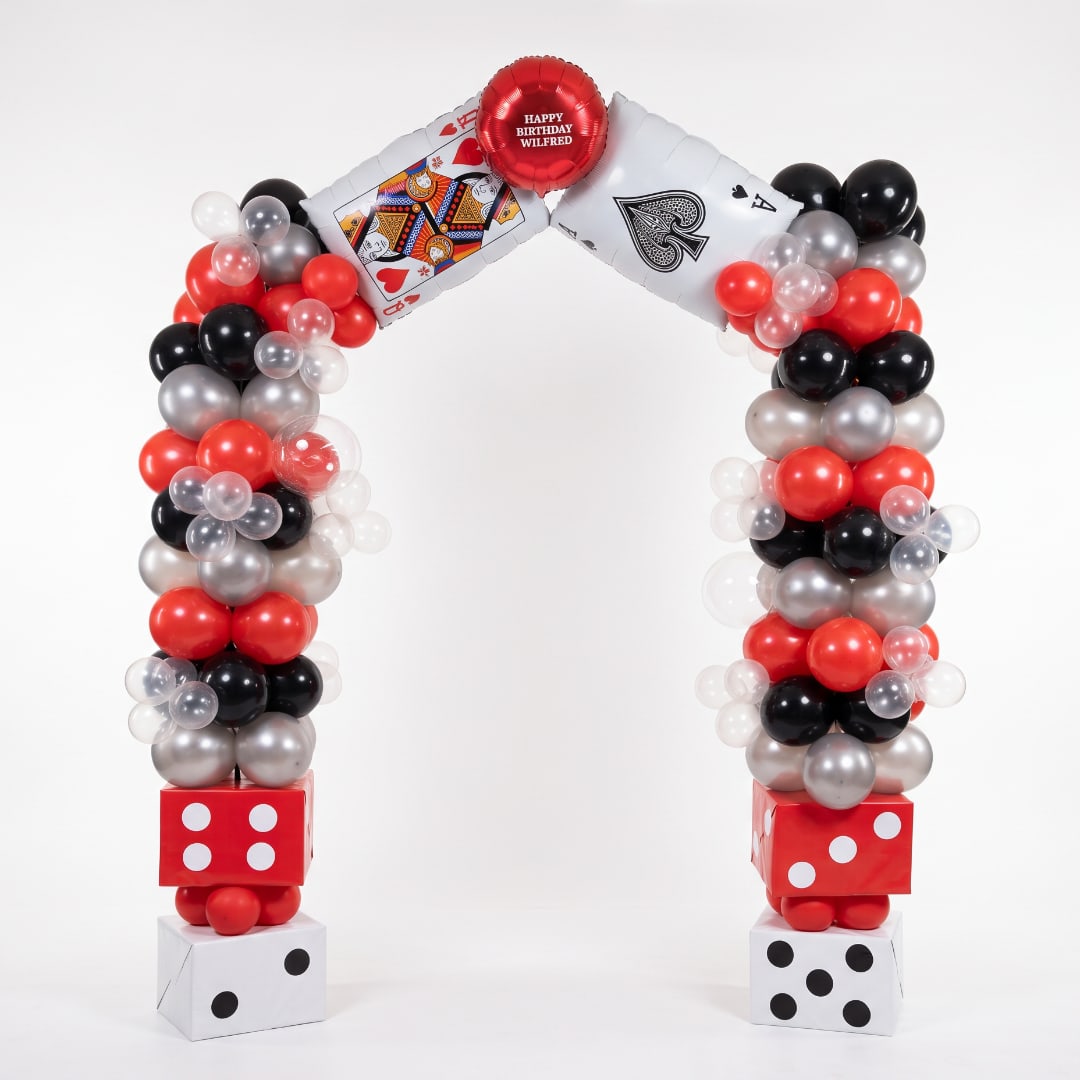 Balloon arch with playing card balloons and dice blocks