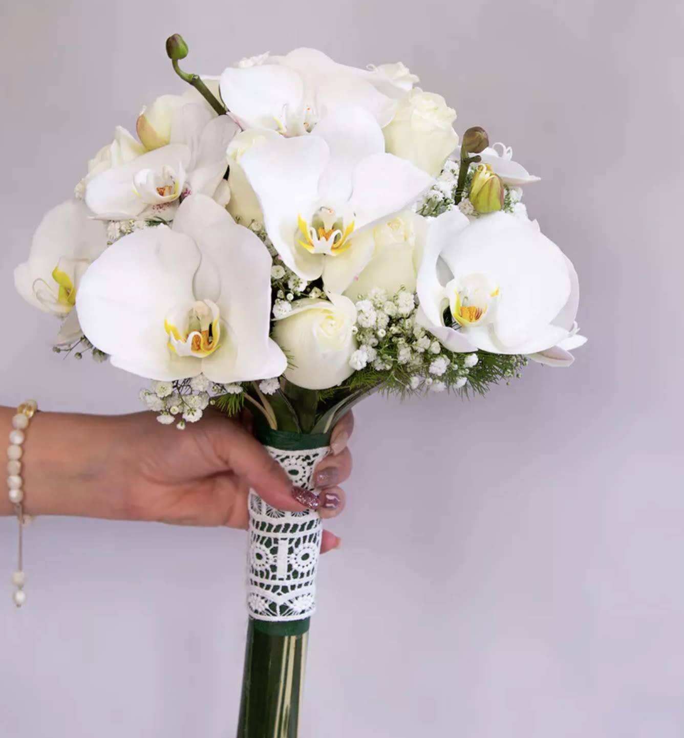 White orchid bouquet with lace-wrapped handle