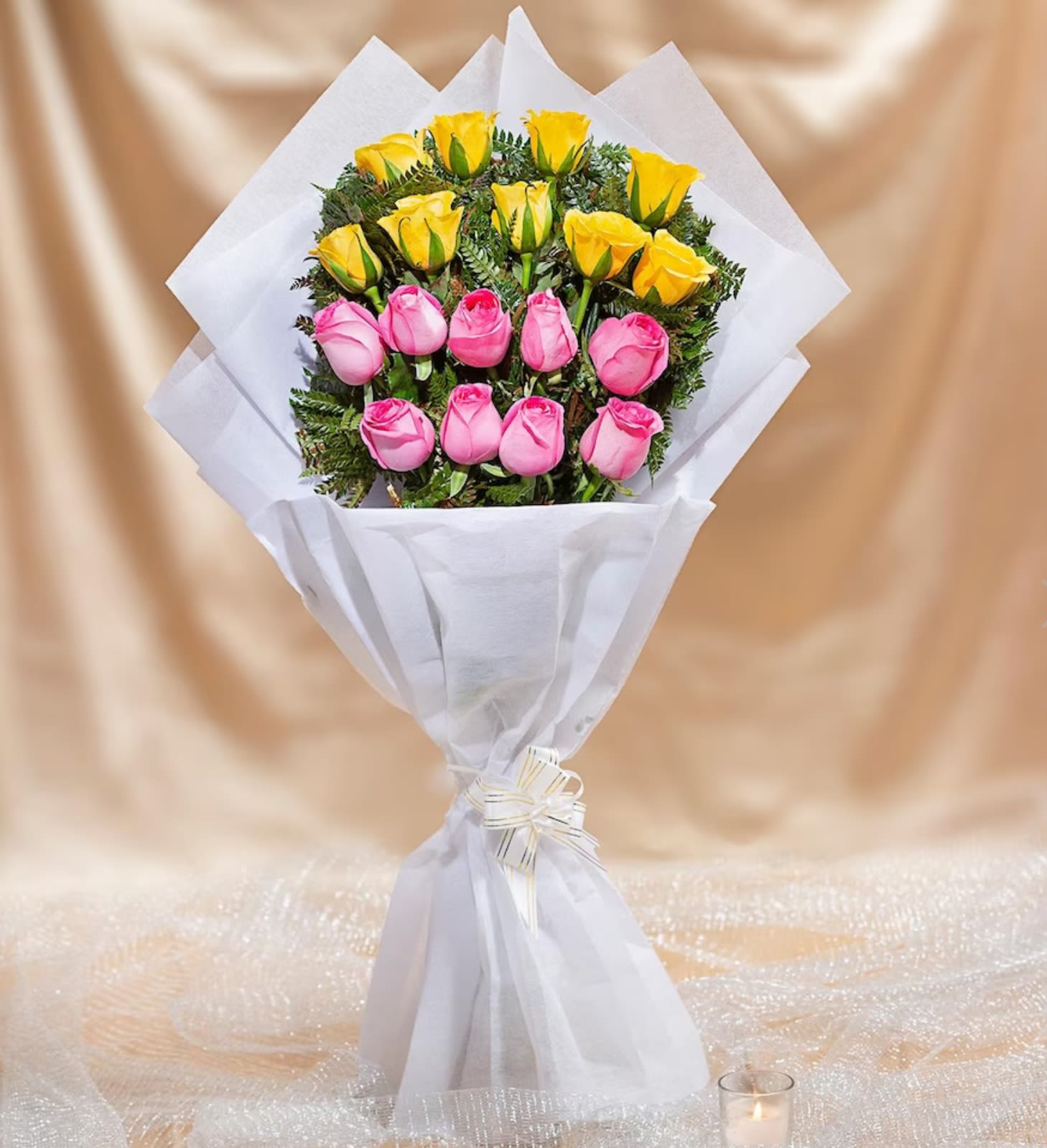 Bouquet of pink and yellow roses wrapped in white paper