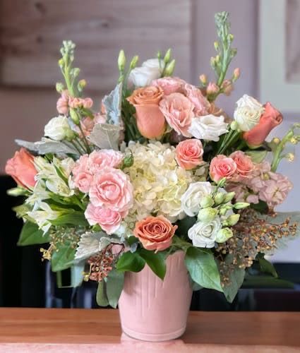 Pink and white rose bouquet in a pink vase