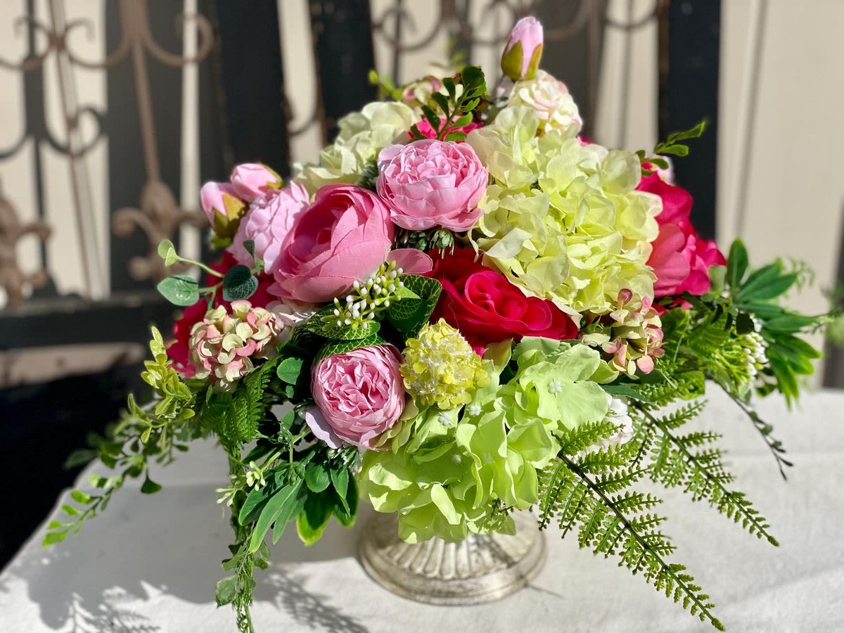 Pink and green floral arrangement in a clear glass vase