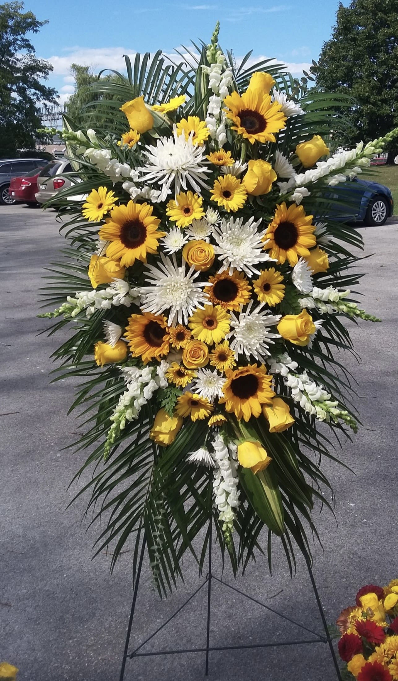 Compassion  - Pink roses, lilies, and more come together for a blushing pink standing funeral spray. 