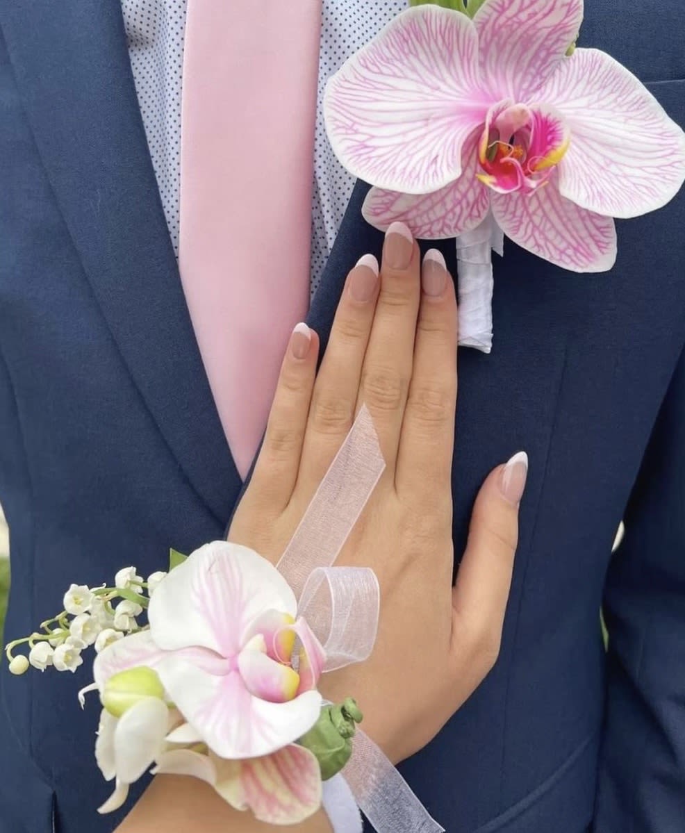 Blush Orchid Harmony - Blush Orchid Harmony Celebrate love and elegance with our “Blush Orchid Harmony” matching corsage and boutonniere set. Designed with delicate pink orchids, soft white blooms, and graceful ribbon details, this luxurious floral pair brings a romantic and sophisticated touch to weddings, proms, engagements, and unforgettable celebrations.  Perfectly coordinated for couples who want every detail to feel timeless, stylish, and beautifully connected. Handcrafted with care to make your special moments even more memorable.