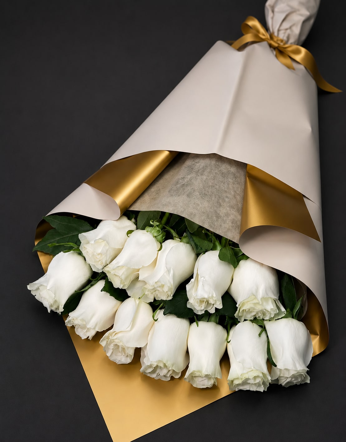 White Roses-SameDay Delivery - Embrace elegance and purity with our White Roses Boutique – a timeless arrangement of fresh white roses, beautifully accented with lush greenery. Wrapped in soft, premium paper and tied with a delicate ribbon, this bouquet is perfect for weddings, anniversaries, or any occasion that calls for a touch of grace and sophistication. Order now to share the beauty and serenity of white roses with someone special!