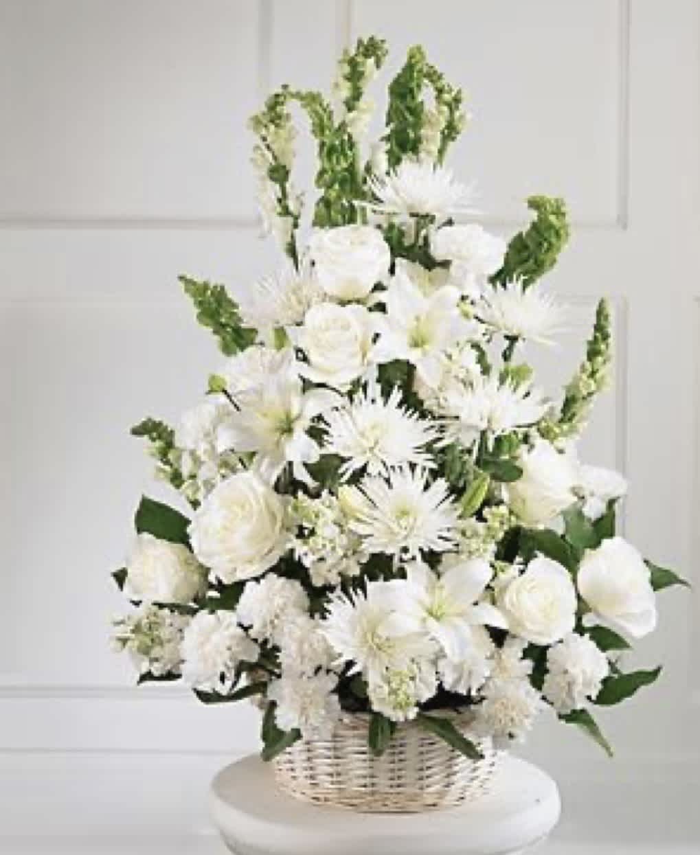 White floral arrangement in a wicker basket