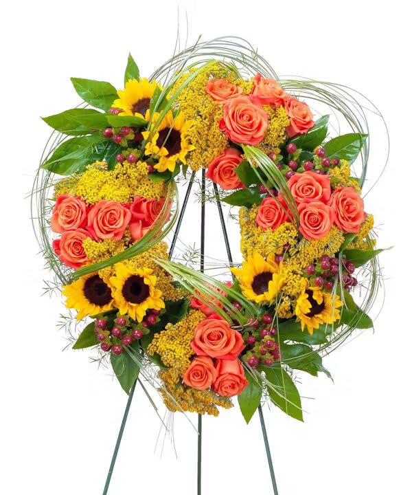 HEAVEN'S SUNSET WREATH - The colors of sunset are evident in this beautiful wreath including sunflowers and roses with accents of other premium flowers and foliage.  