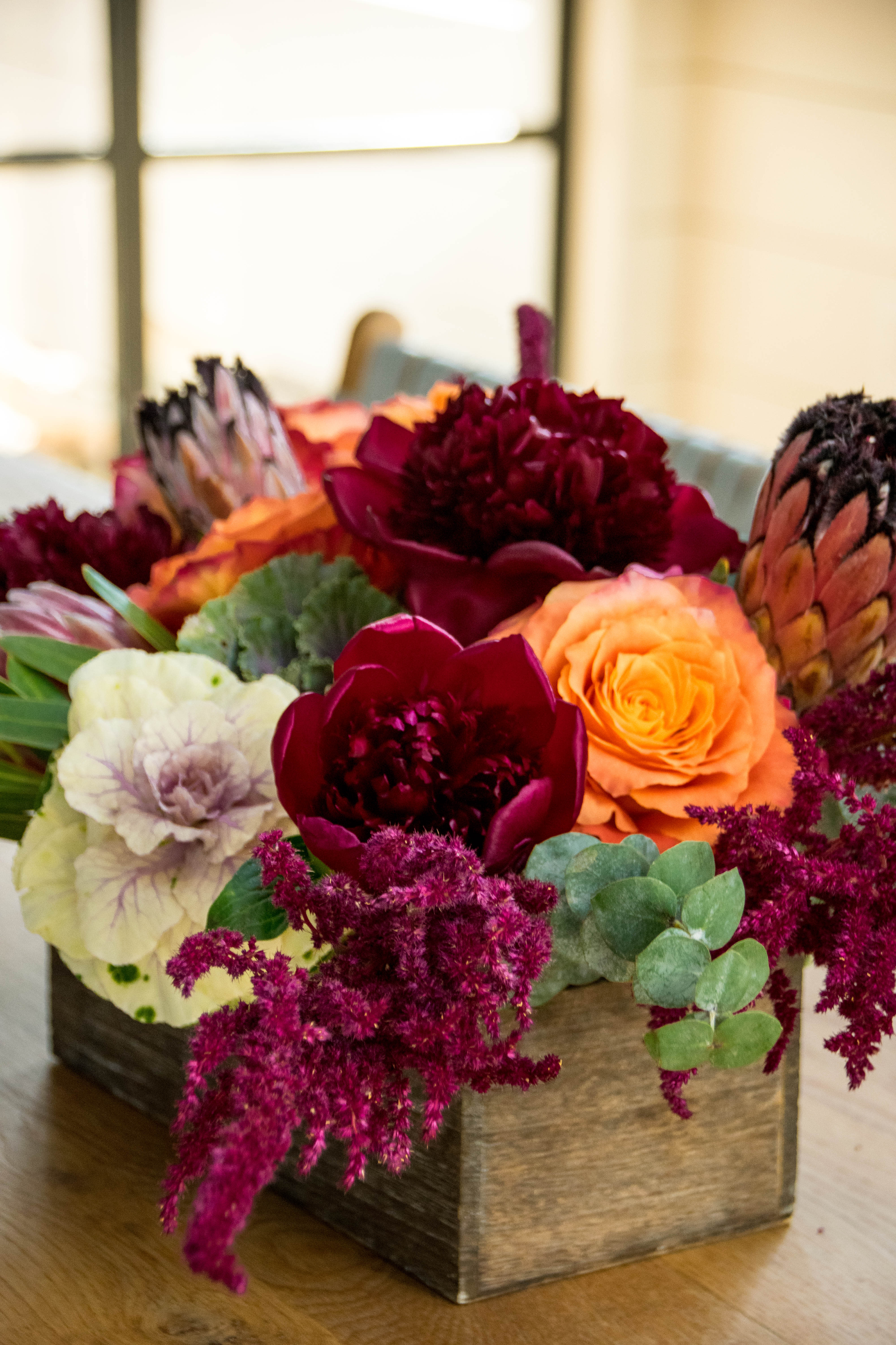 Beautiful dinner centerpiece.  - Peonies, proteas, kale and the lovely lovely Free Spirits. 