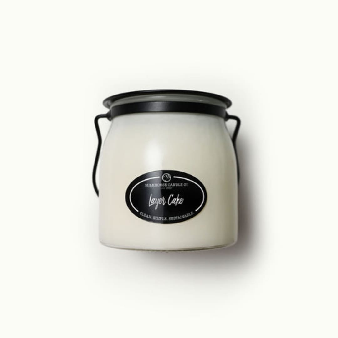 White candle in a black-lidded jar with a handle