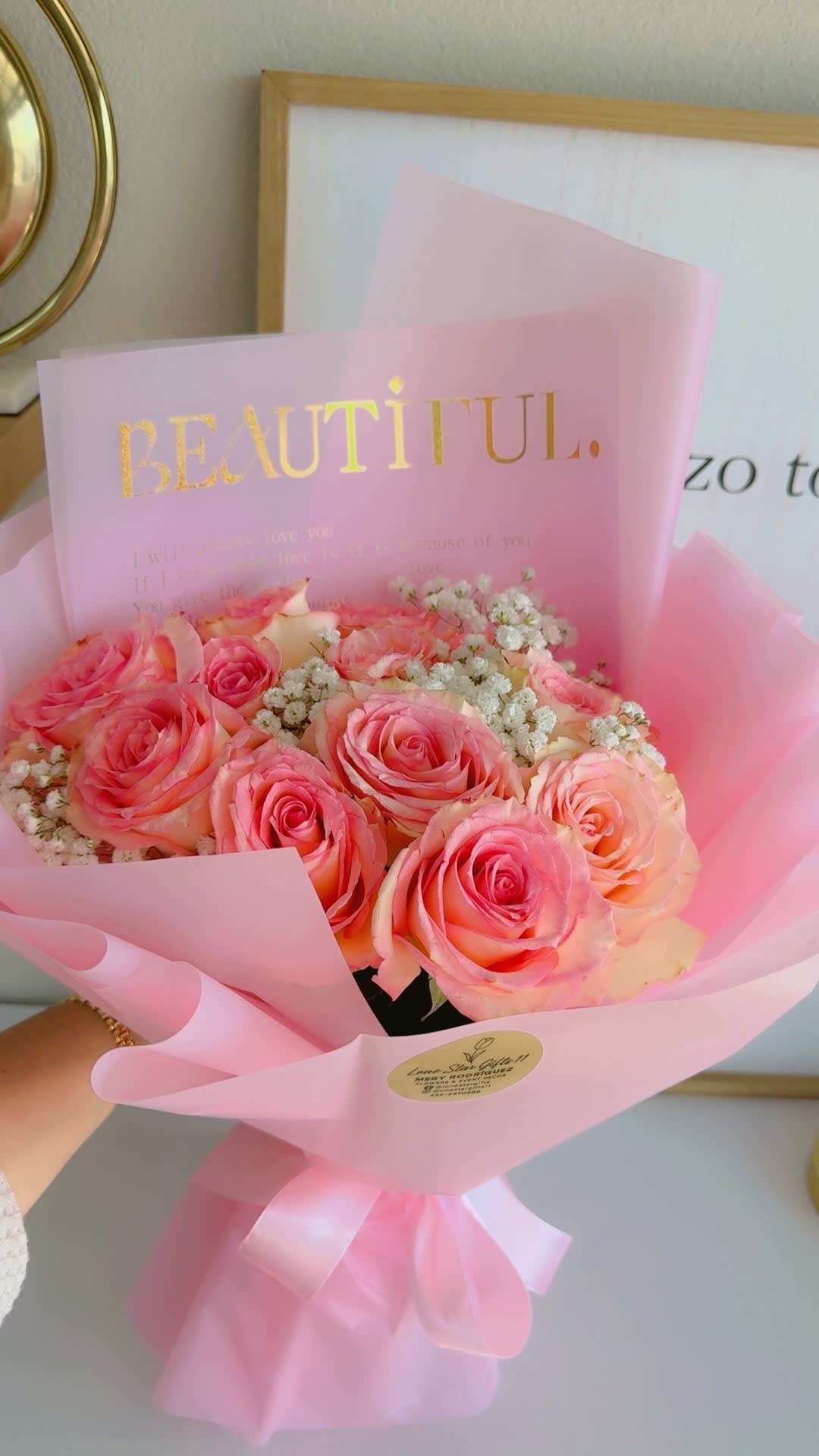 Pink rose bouquet wrapped in translucent paper with a gold "BEAUTIFUL" card