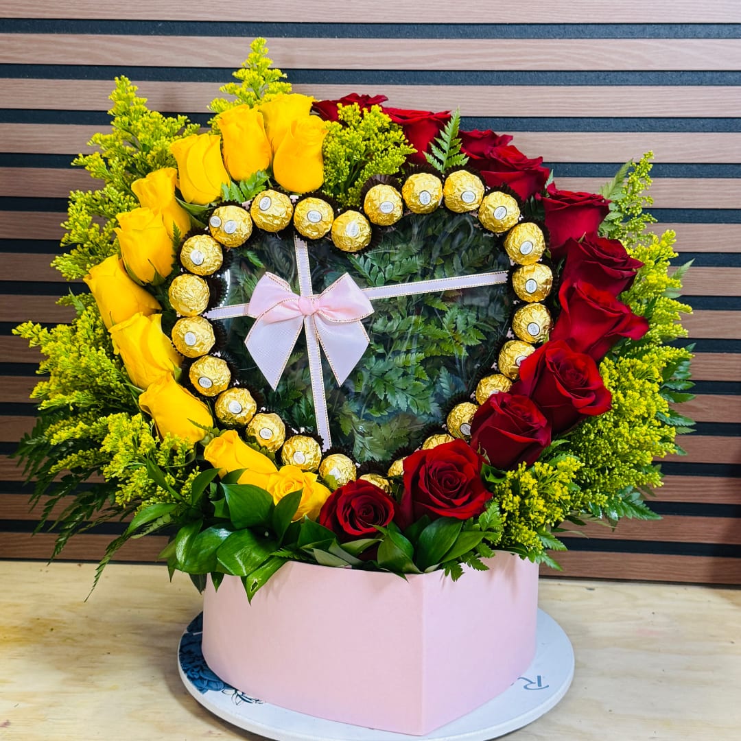 Heart-shaped rose arrangement with Ferrero Rocher chocolates in a pink box