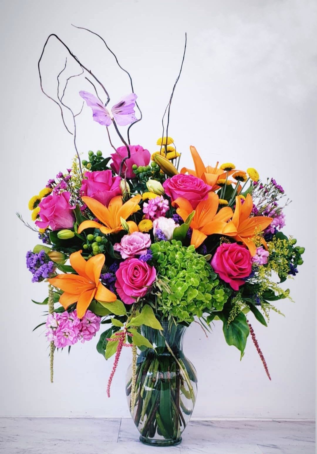 Butterflies - "Kiss full of color, makes me wonder where you've always been I was hiding in doubt 'til you brought me out of my chrysalis And I came out new All because of you Butterflies..." We capture the beauty of Spring in this beautiful artisan arrangement of bright blooms. Each arrangement will be unique and vary from the picture, as our designers will create from the freshest and brightest flowers delivered to our shop each morning from the flower fields. Each will be a creation of love, beauty and inspire... Butterflies.  Approximate size: 30" Tall x 24" Wide From Long Beach CA Favorite and Premier five 5 star flower shop, offering same-day delivery service, A Beautiful California Florist. 
