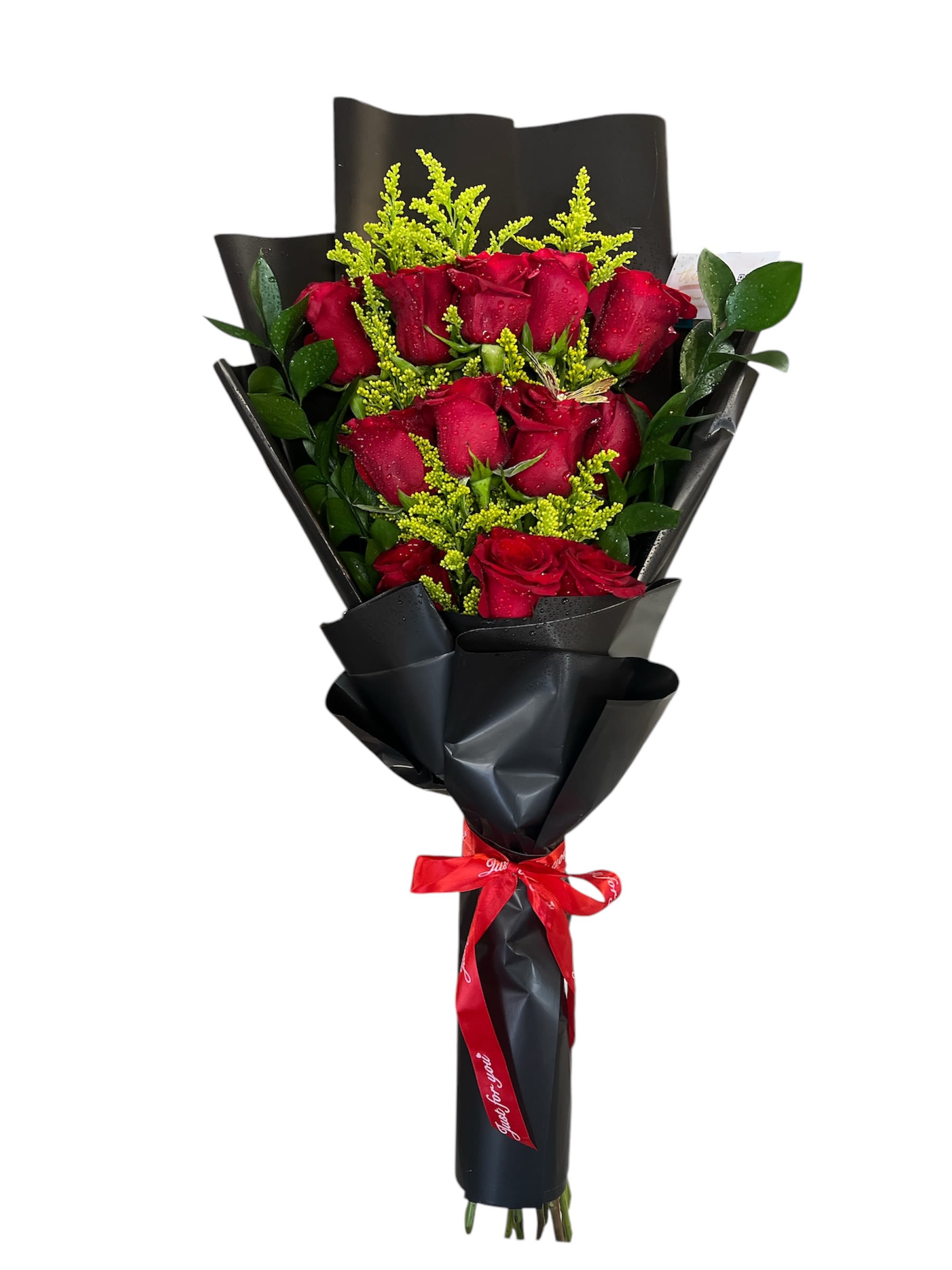 Bouquet of red roses wrapped in black paper with a red ribbon