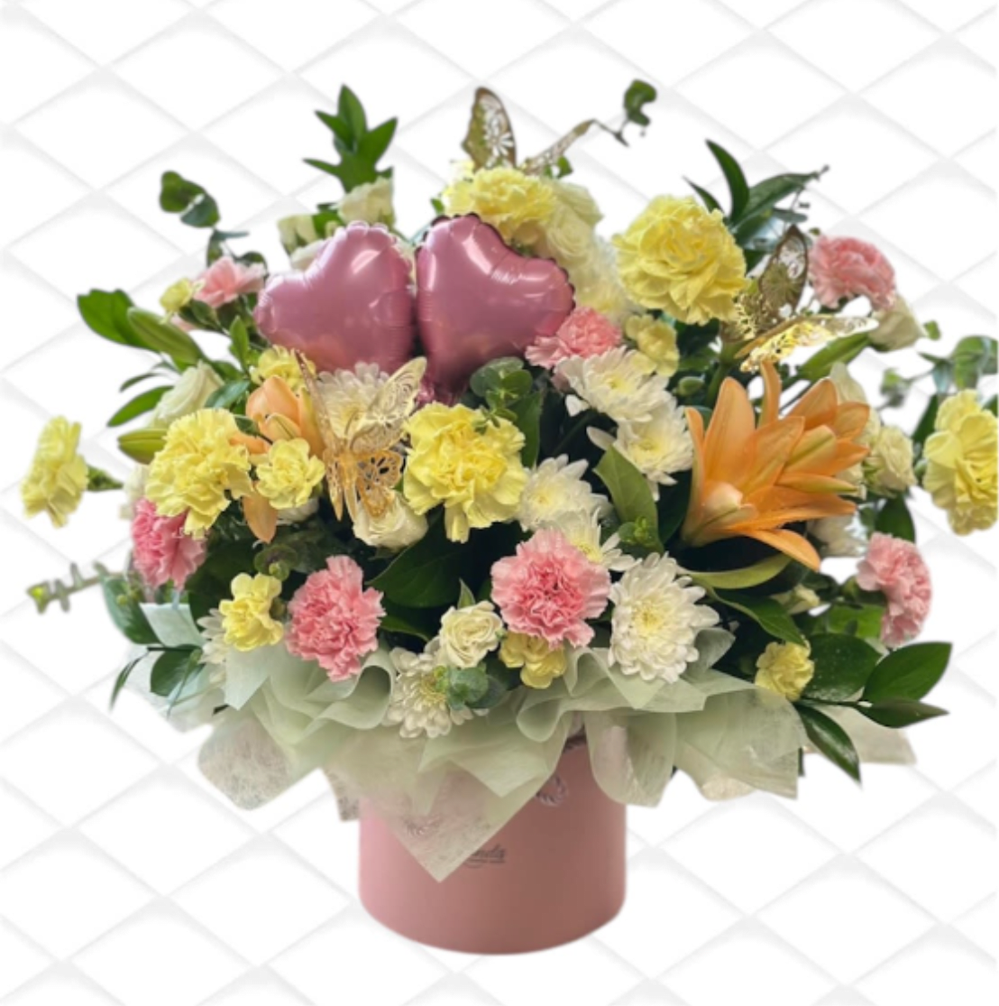 Pink heart balloons in a mixed flower arrangement in a pink box