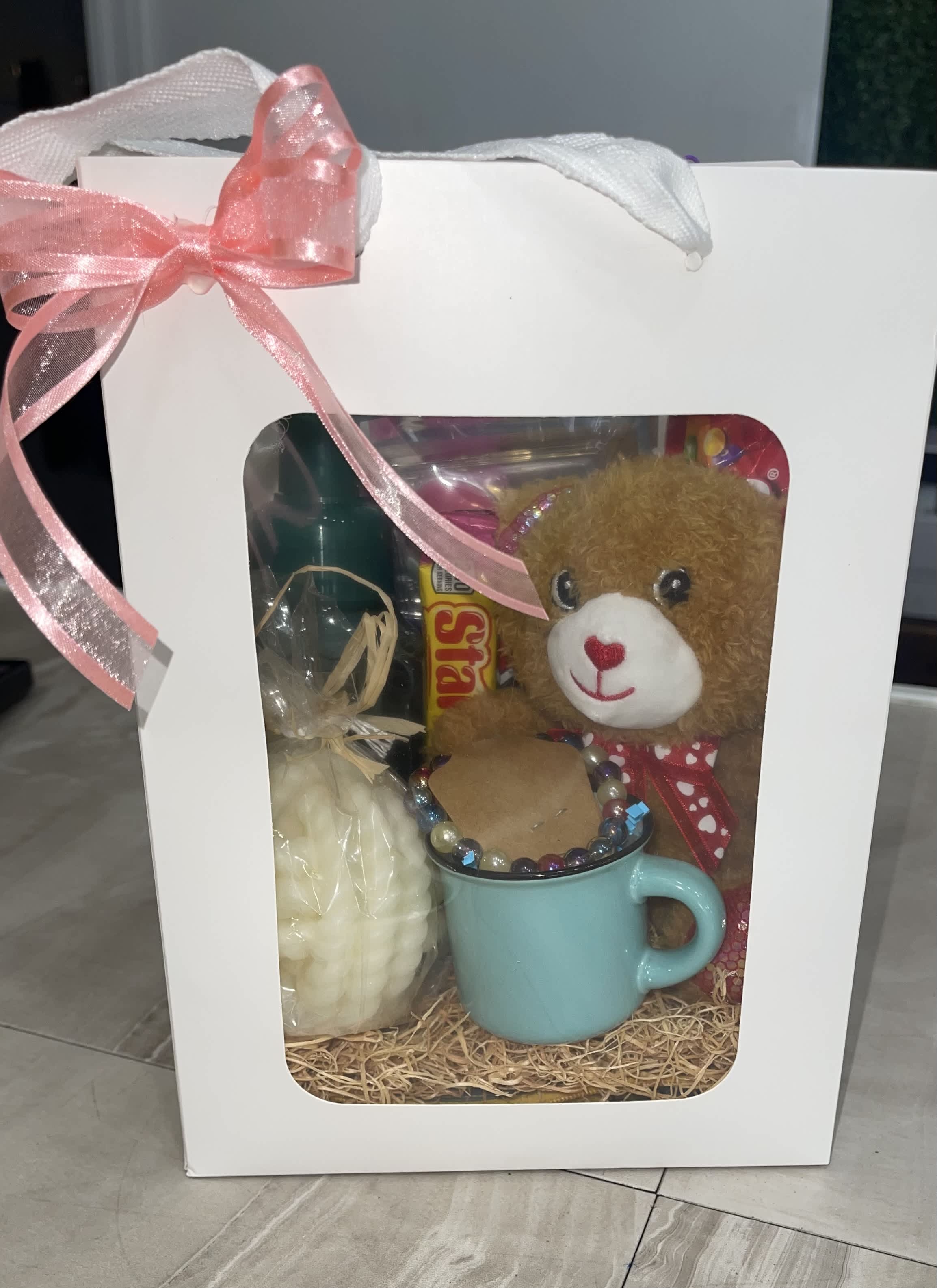 Gift box with a teddy bear, mug, and candy
