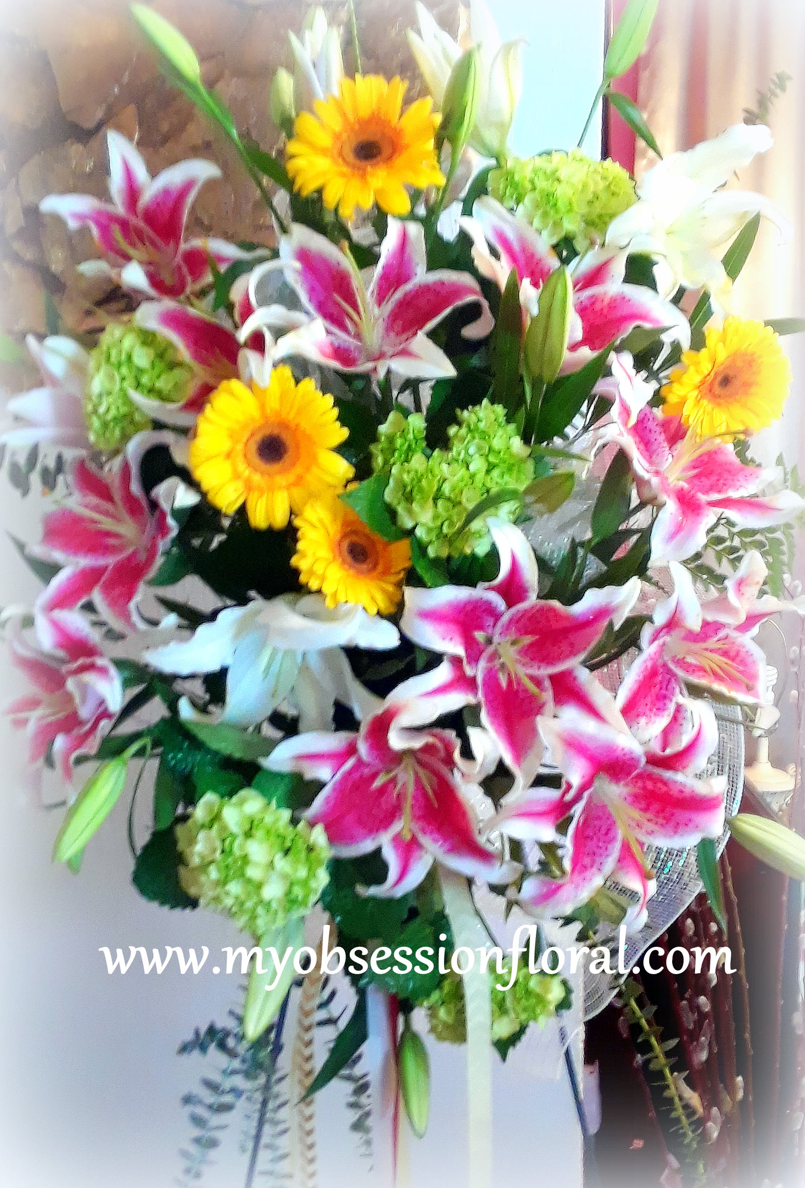 Bouquet of pink lilies, yellow gerbera daisies, and green hydrangeas