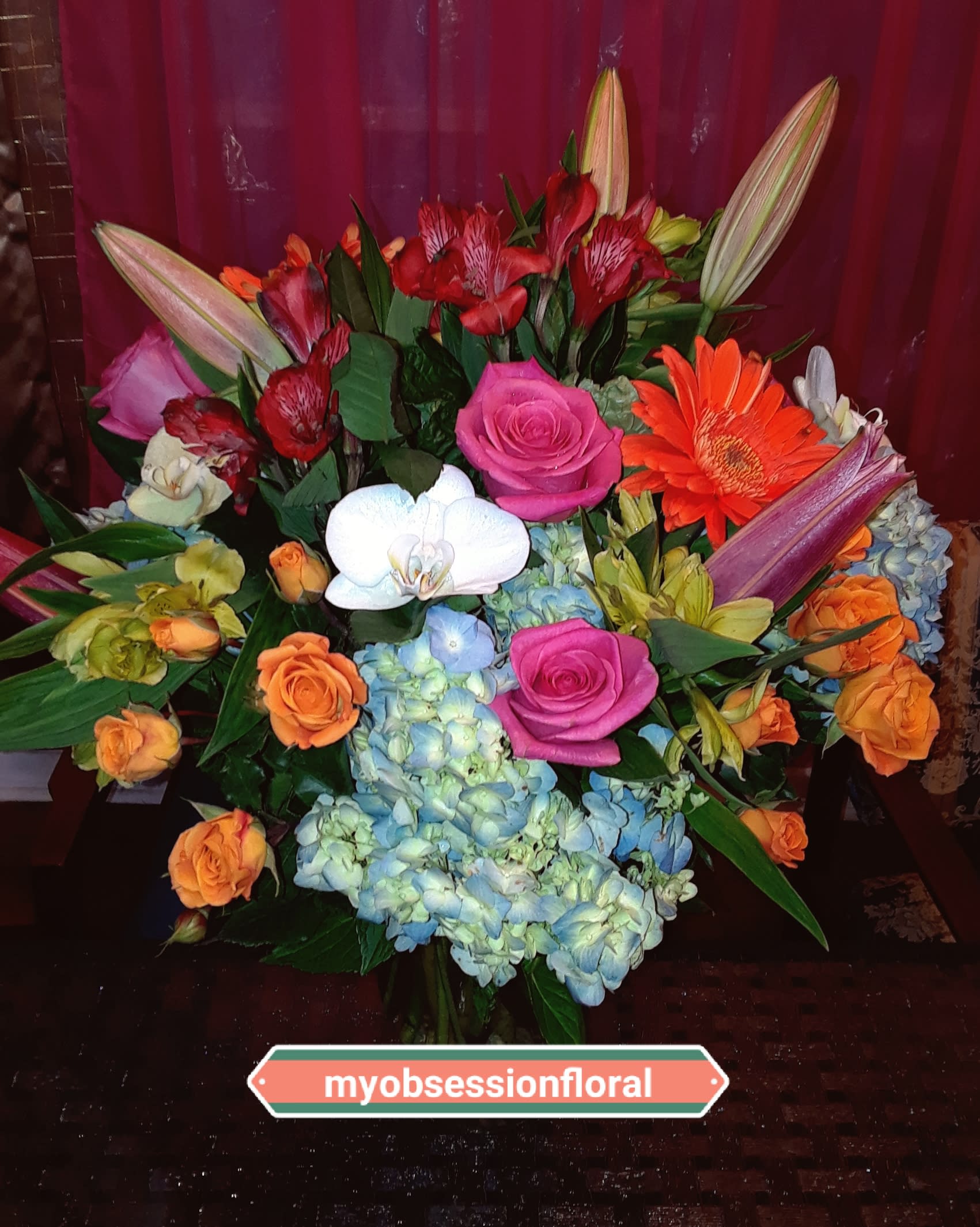 Mixed bouquet with roses, orchids, lilies, gerbera daisies, and hydrangeas