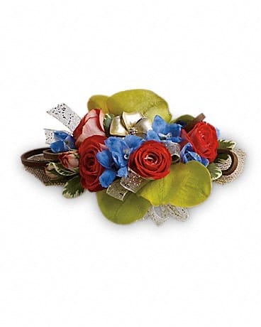 Small bouquet of red roses and blue flowers with ribbon accents