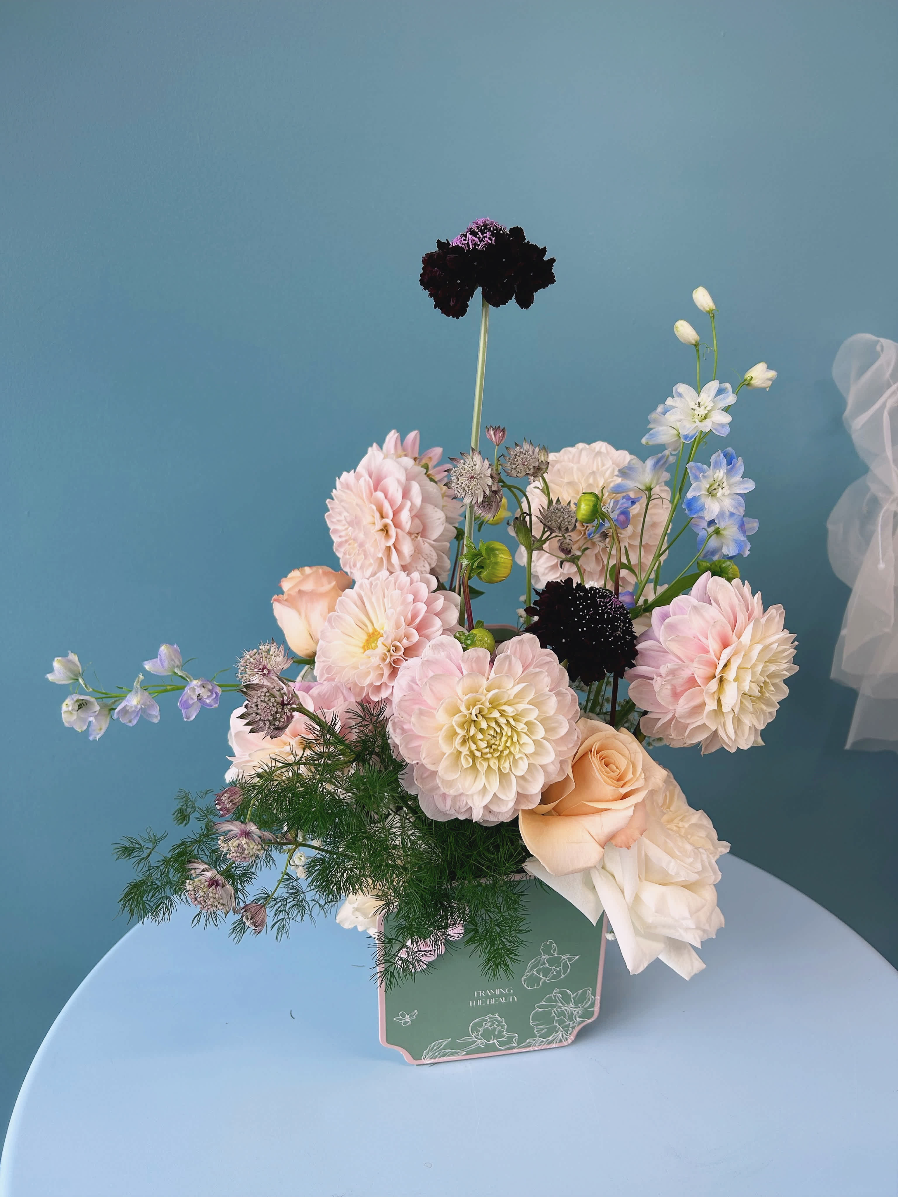 Summer Flower Box - Celebrate the vibrant season with our Summer Bloom Floral Arrangement, showcasing a stunning mix of fresh, seasonal summer flowers and lush greenery. Expertly arranged in a ceramic or glass container, these bright and colorful blooms capture the essence of summer. Presented in an elegant luxury flower box, this arrangement makes the perfect gift or summer décor accent. Add a touch of seasonal beauty to any occasion with our premium summer floral collection, carefully packaged for an unforgettable presentation.   standard size : 12-16 stems of florals deluxe size:   20-24 stems of florals premium size:  36-40 stems of florals  Leave us a note at checkout with your preferred color theme and floral variety. While we cannot guarantee an exact match, we will make every effort to design your arrangement as closely as possible to your request.