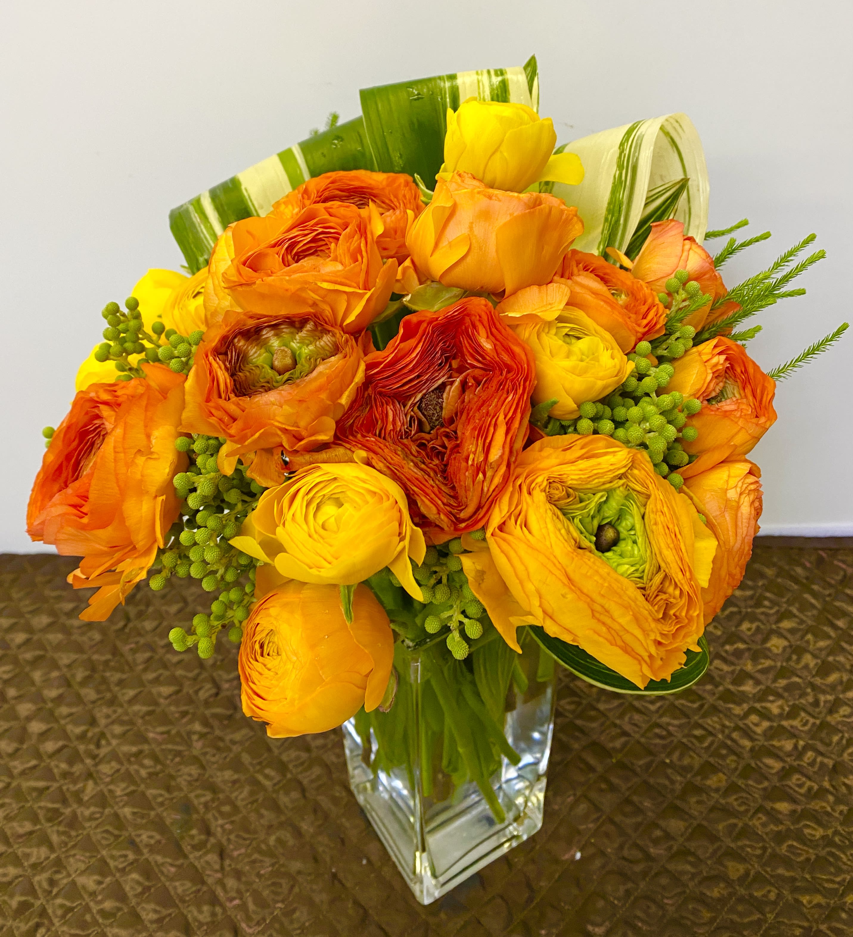 Orange and yellow bouquet in a clear glass vase